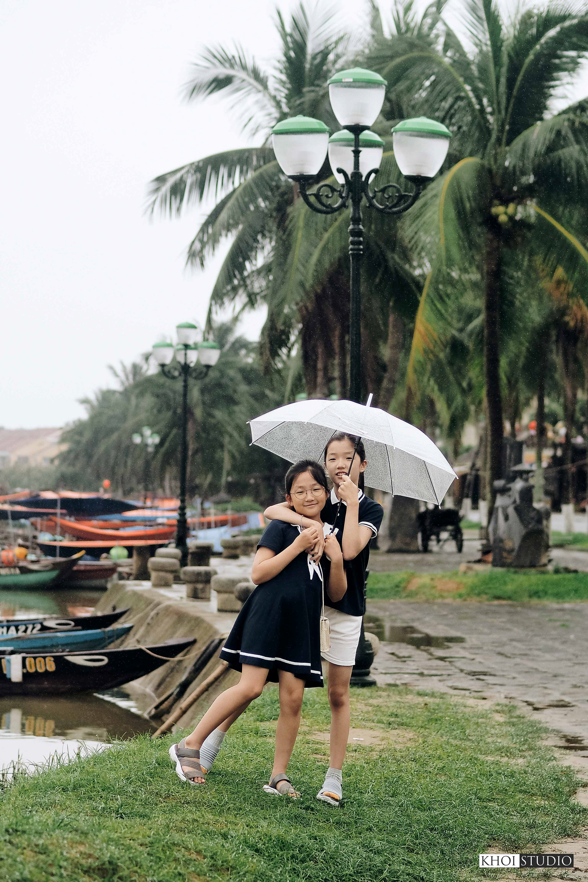 Family together on a rainy day in Hoi An ancient town | Tourist from South Korea