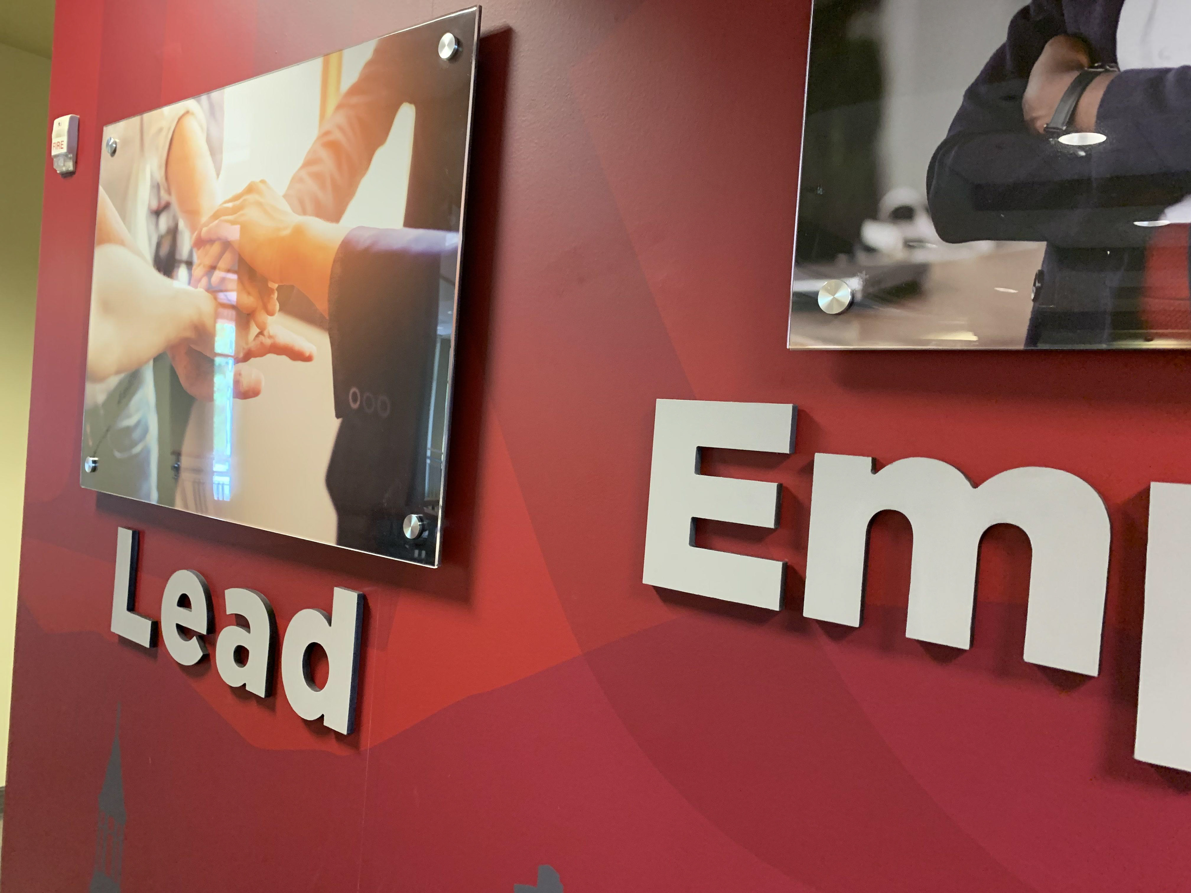 Second-surface printed polycarbonate panels with dimensional PVC lettering