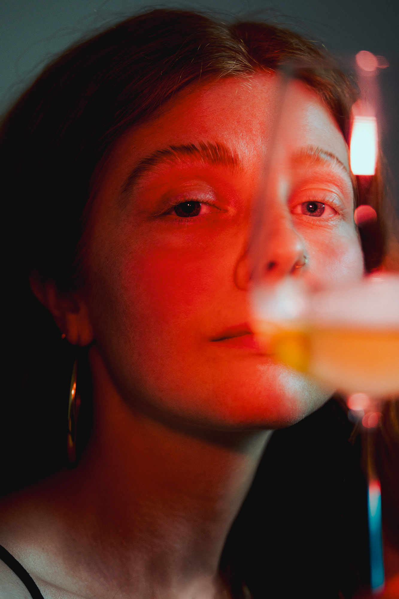 Portrait of Georgina under red lighting, Copenhagen, 2025