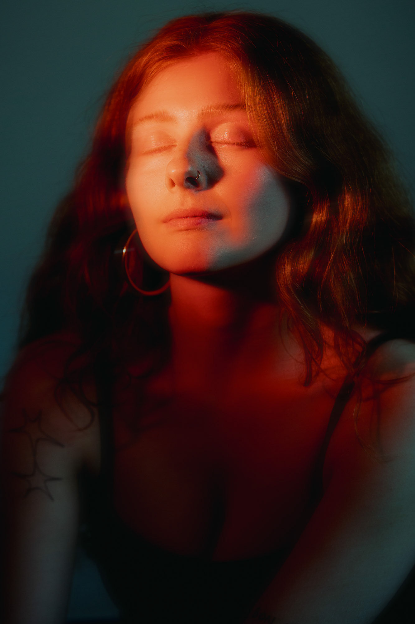 Portrait of Georgina under red lighting, Copenhagen, 2025