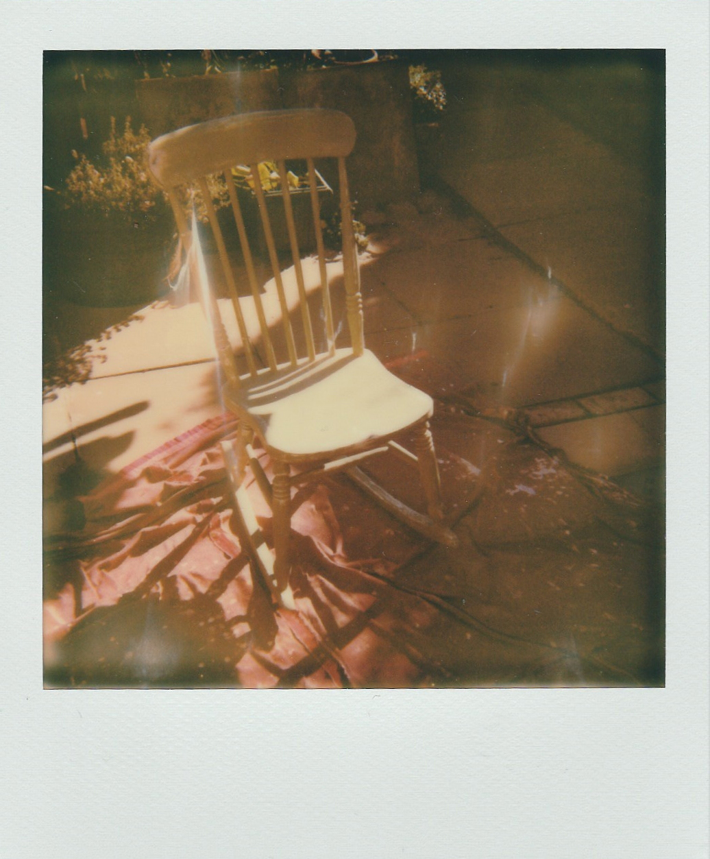 Distressing the paint to bring back the old black paint to give a gentle reminder of where the rocking chair came from.