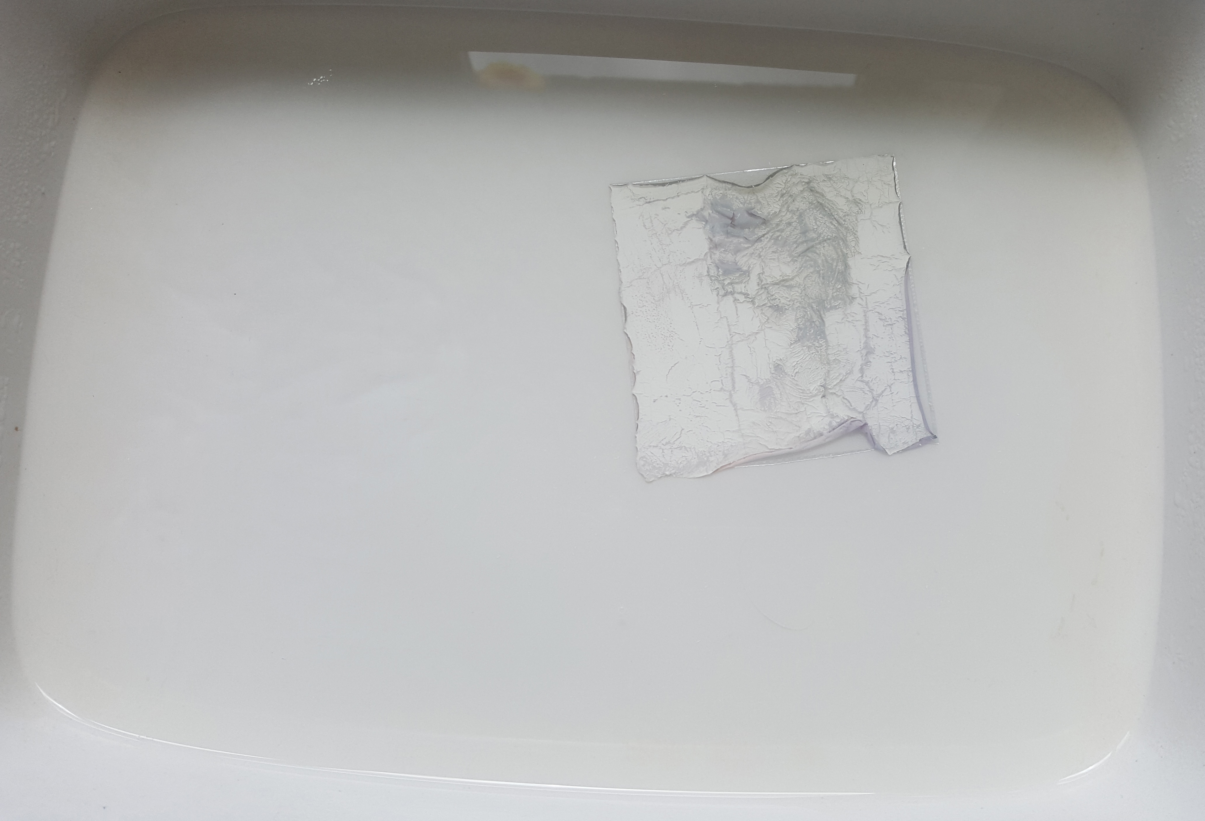 The film will start to come away from the front plastic film sheet leaving behind the plastic and a slightly yellowish jelly like material. This can be taken off by hand if it doesn't remain stuck to the plastic film sheet but is a real pain to do as the film rips so easily.