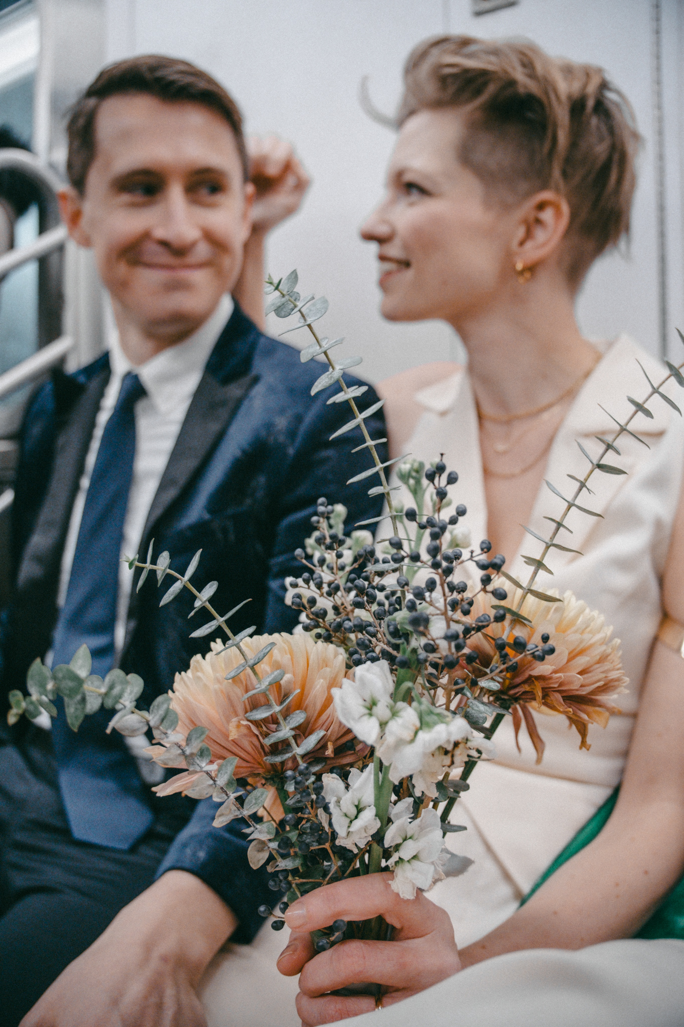 Candid photo of a couple on the NYC subway after a wedding