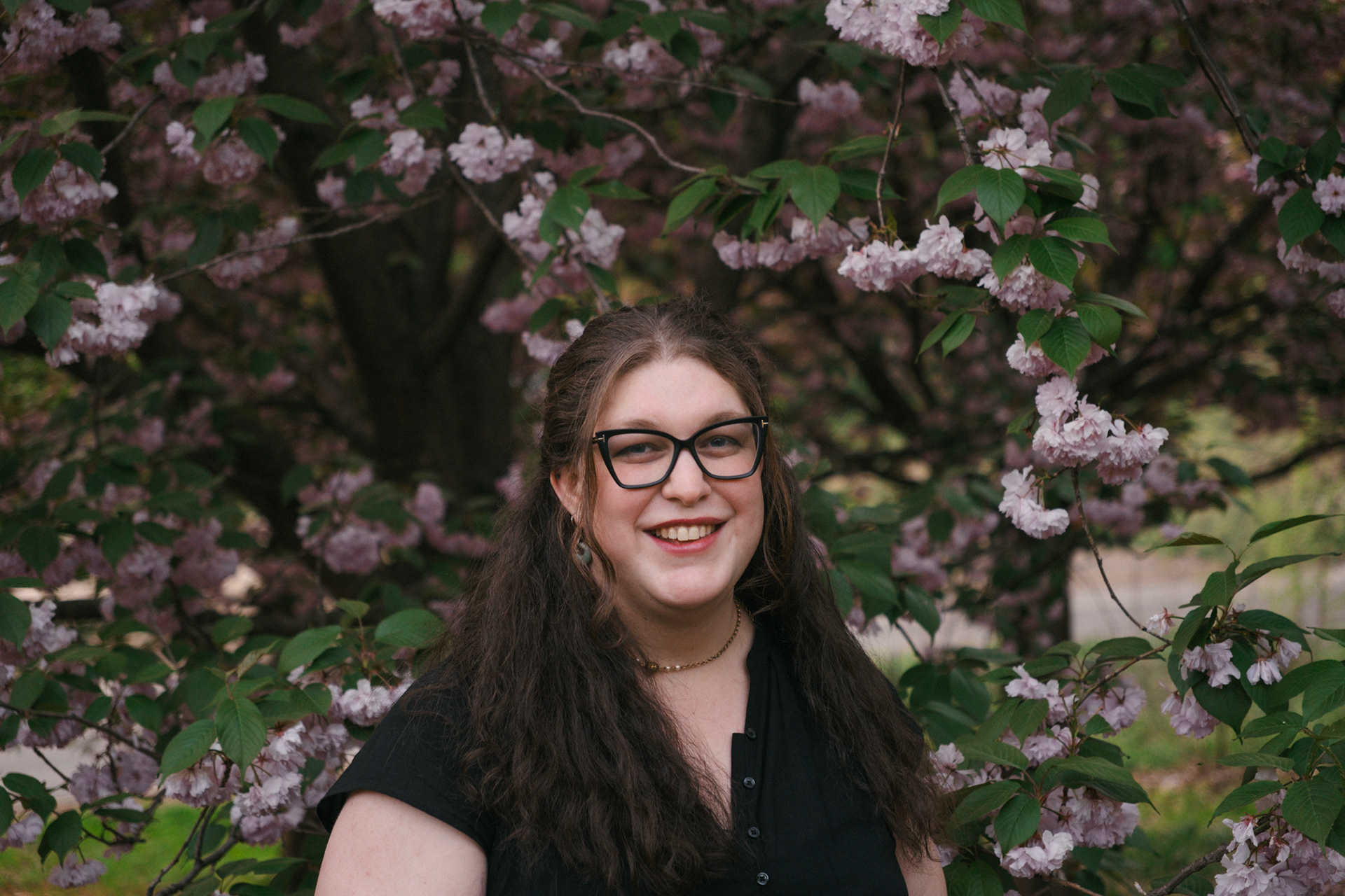 Queer author Madeline Trice posing for a photoshoot in Prospect Park NYC