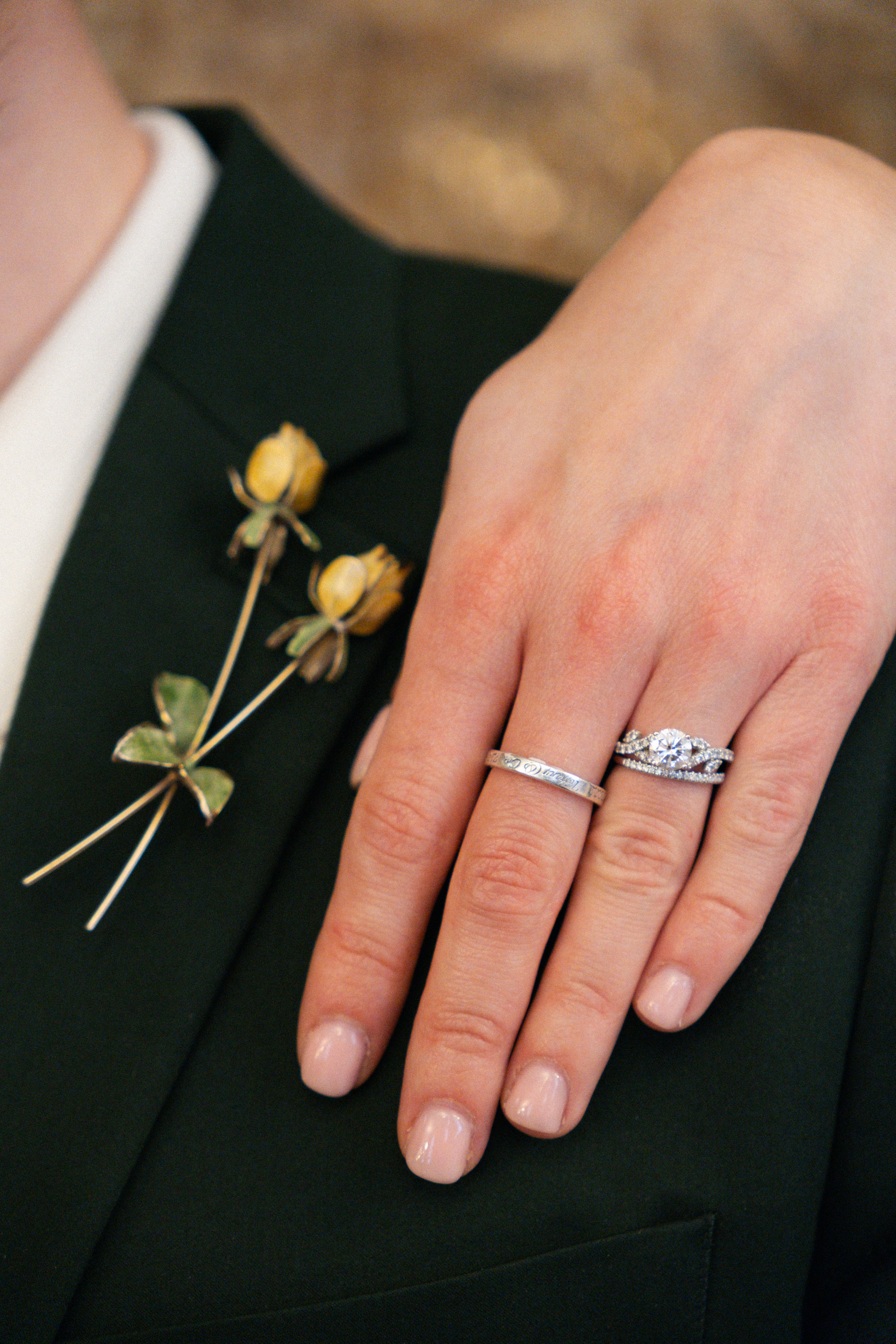 Close up of wedding ring and Flower Lapel Pin