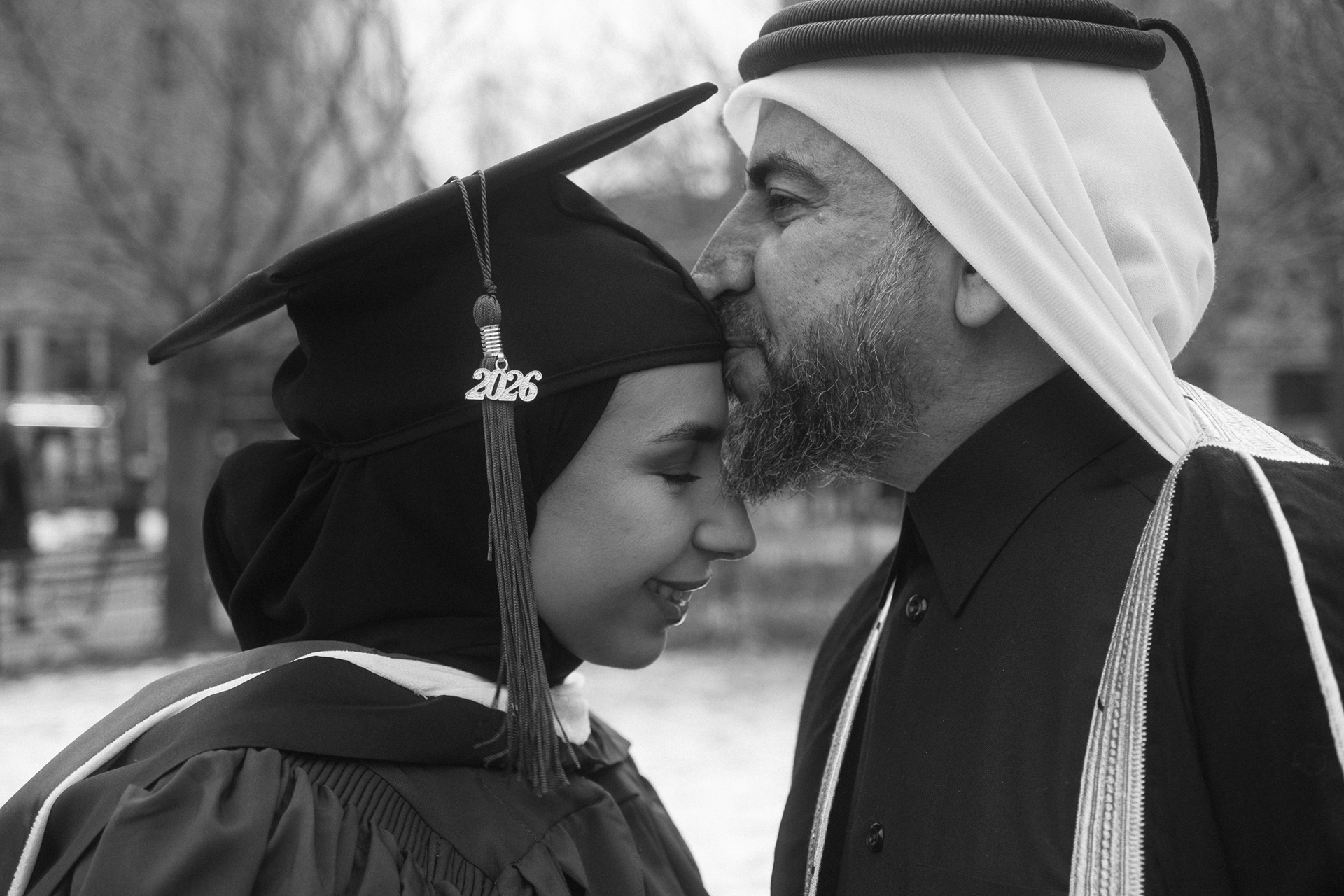 Close-up documentary-style graduation photo capturing emotion and pride after NYU master’s ceremony