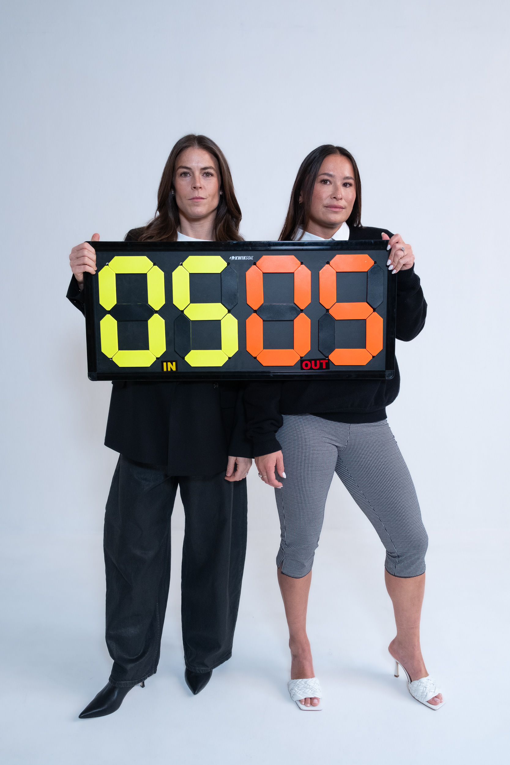 Podcast hosts Kelley O’Hara and Ali Riley in a studio photoshoot for promotional branding photos