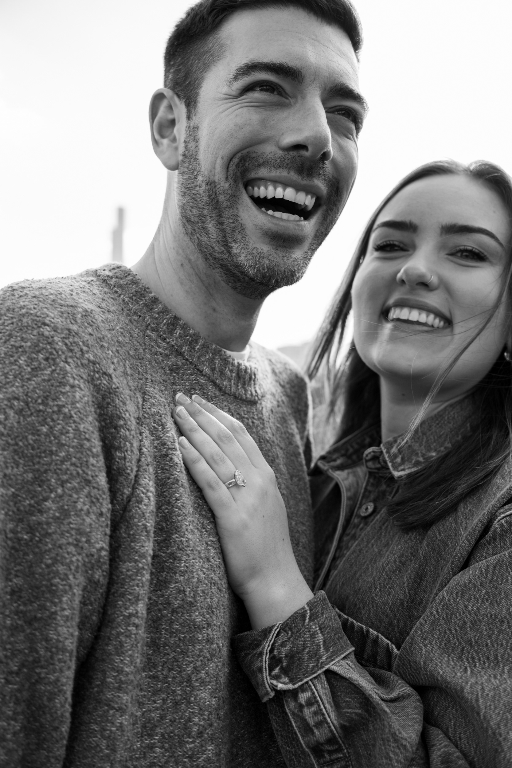 Black and white candid portrait of a cuple after a proposal at the hernshead central park