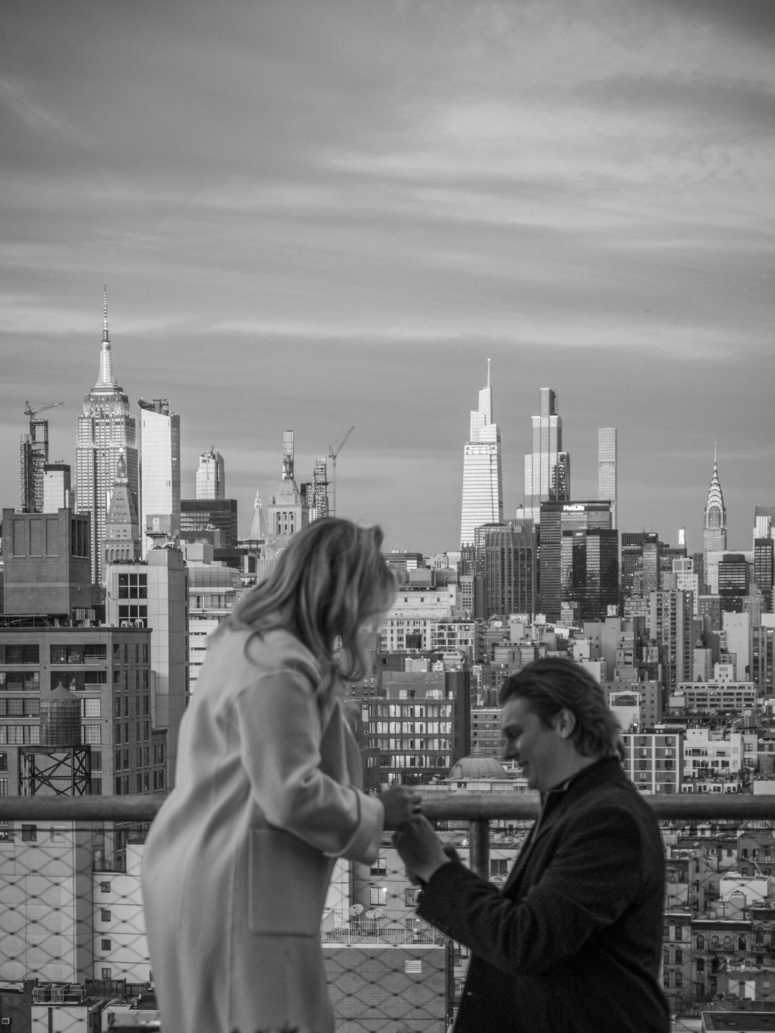 Black and white photo of a proposal with the NYC skyline in the background