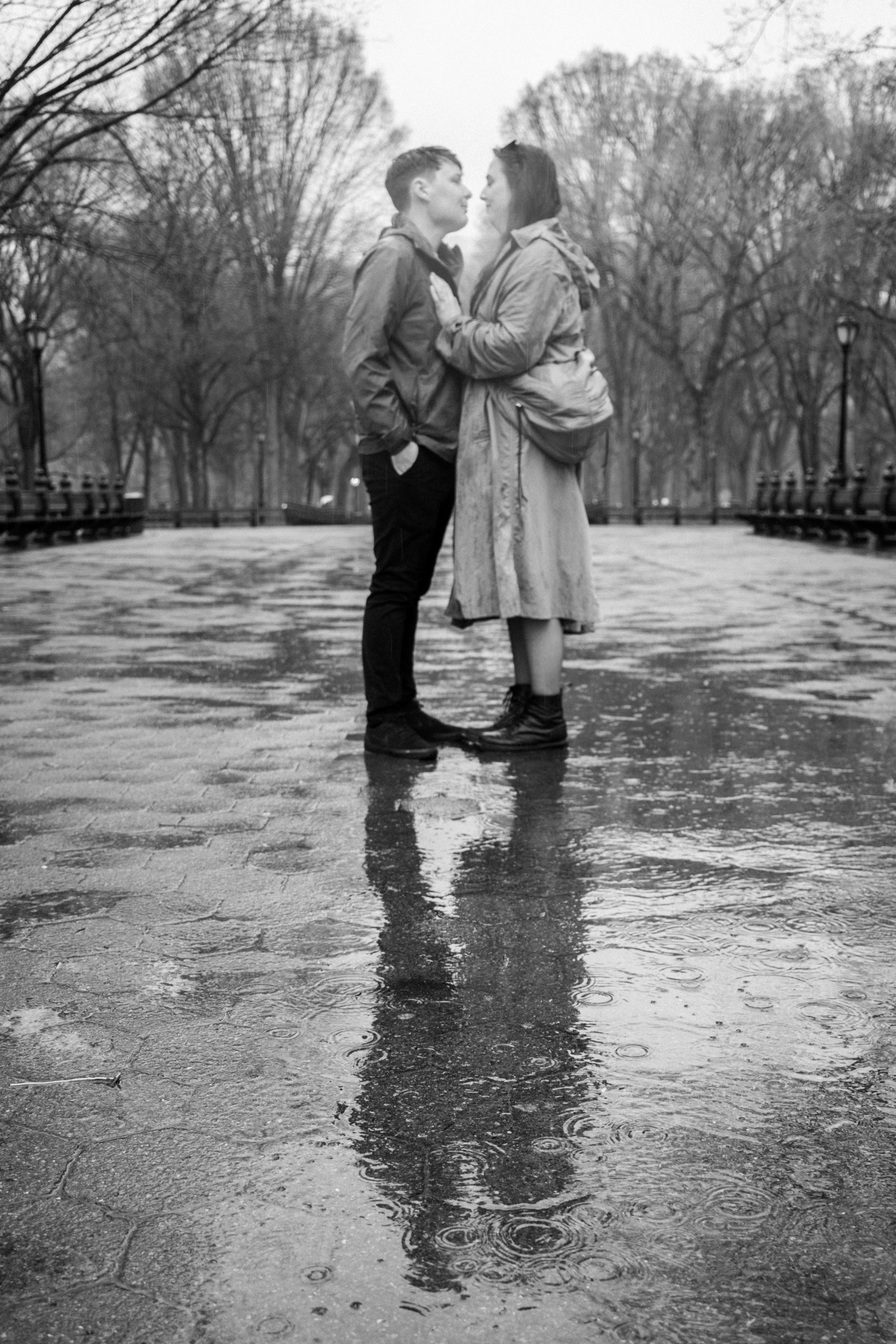 couple kissing at The Mall in Central Park on a rainy day