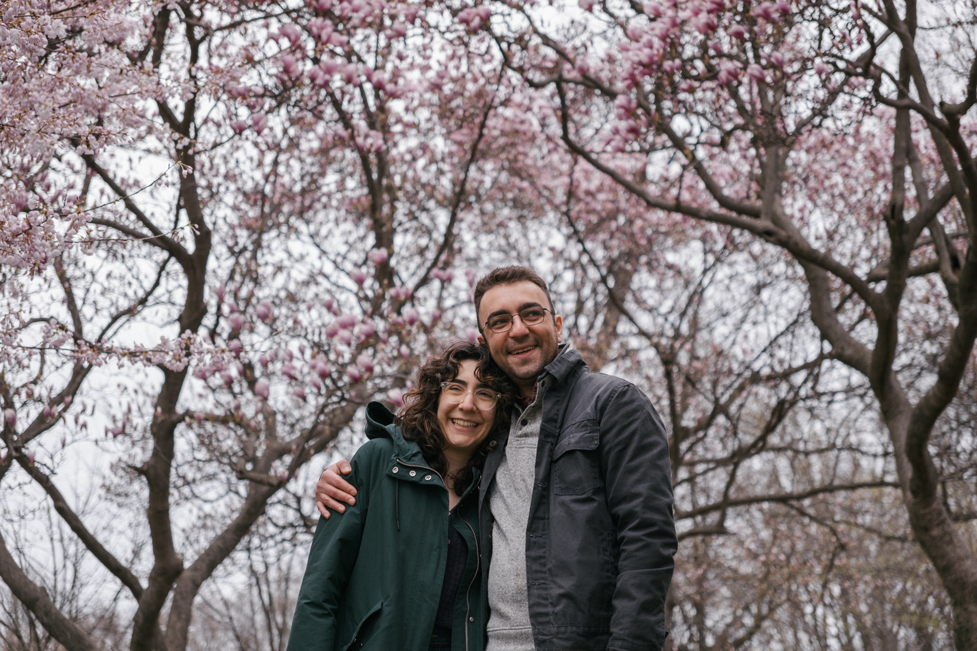 Candid portrait of a couple in Prospect Park for a cherry blossom engagement session