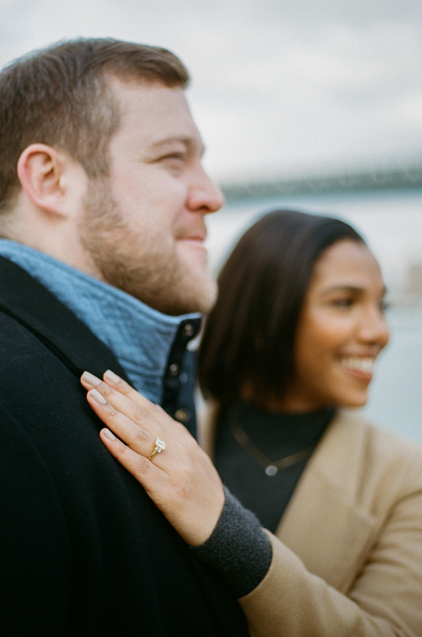 Documentary-style engagement portrait of couple at The Pond, Central Park, NYC