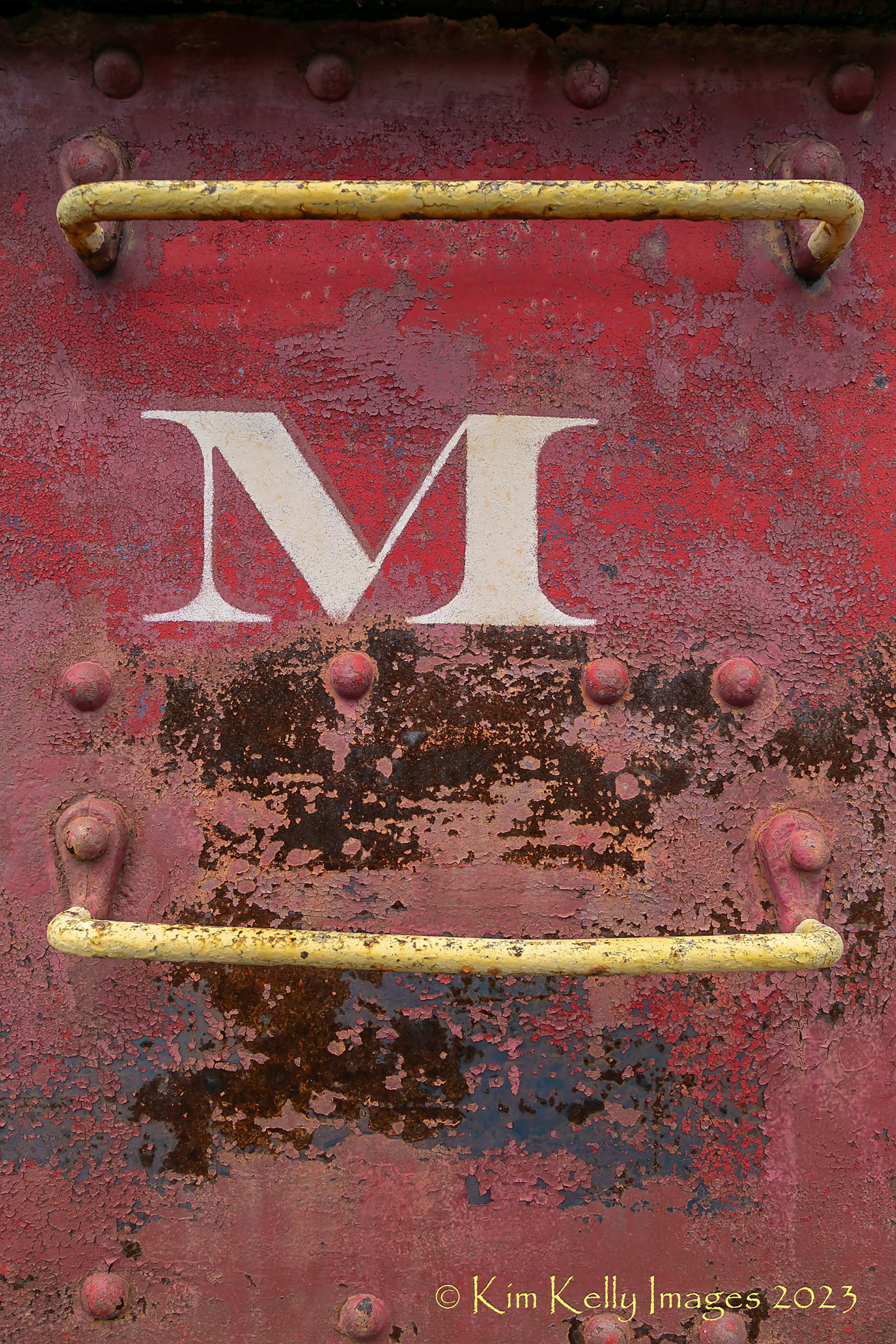 M on a Rusty Train Car