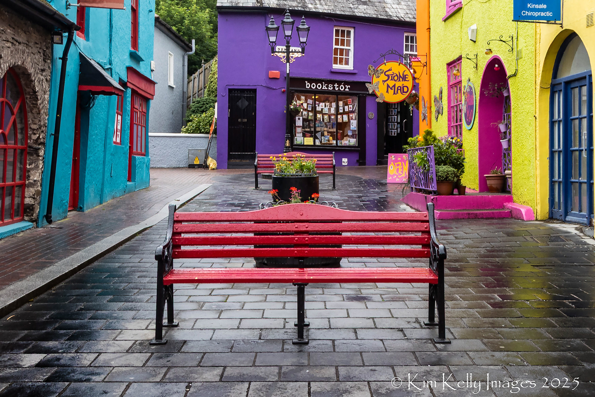 Red Bench Among the Colorful Shops in Kinsale