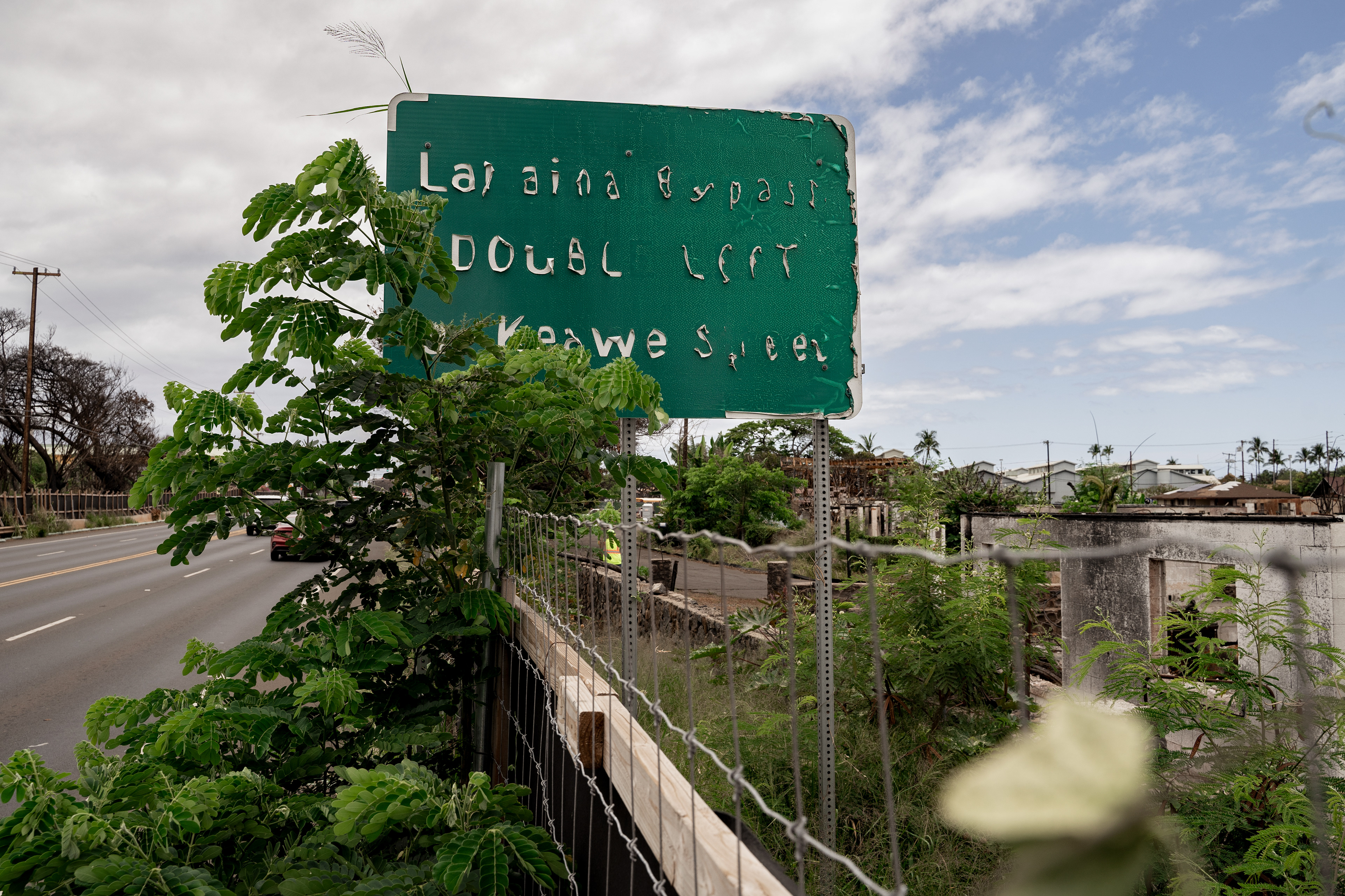 LAHAINA, HI - MAY 24: A melted sign for Lahaina Bypass is pictured on Honoapiilani Highway in Lahaina, Hawaii on Friday, May 3, 2024. (Photo by Mengshin Lin for The Washington Post)