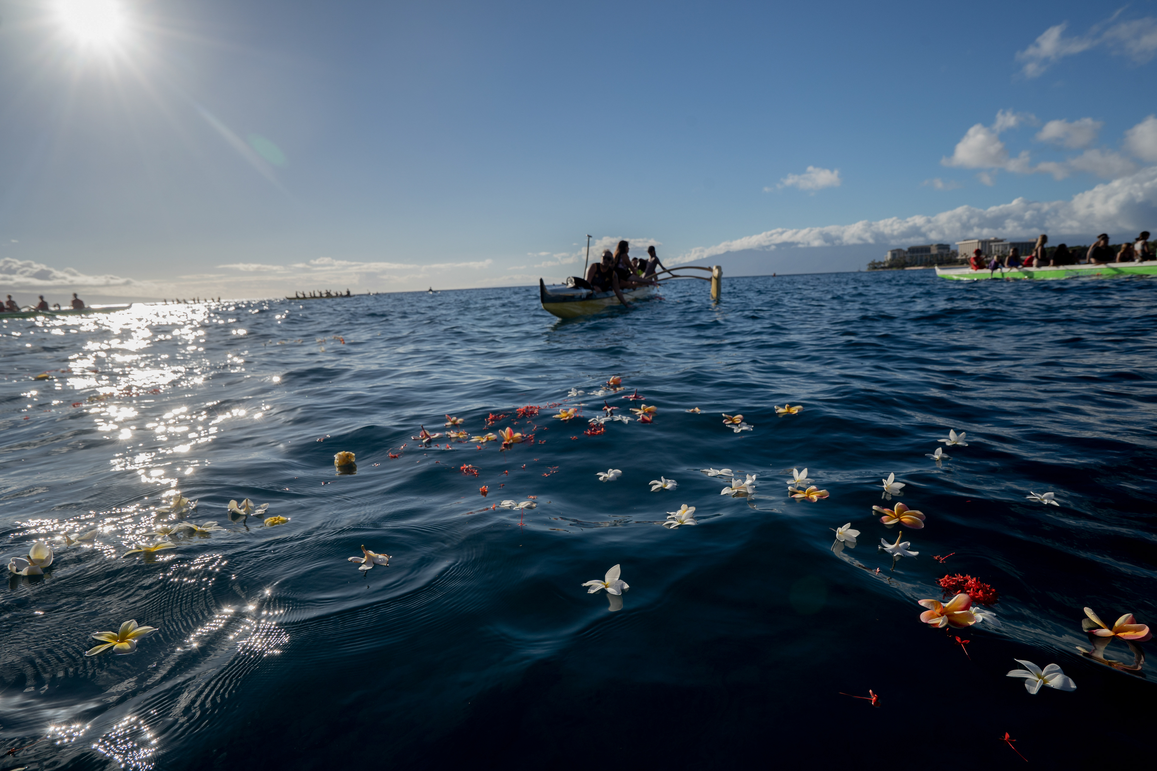 LAHAINA, HI - SEPTEMBER 8: Dozens of flowers are pictured during a memorial paddle out on the one-month anniversary of the Lahaina Fire at Hanakaoo Park in Lahaina, Hawaii on September 8, 2023. (Photo by Mengshin Lin for The Washington Post)