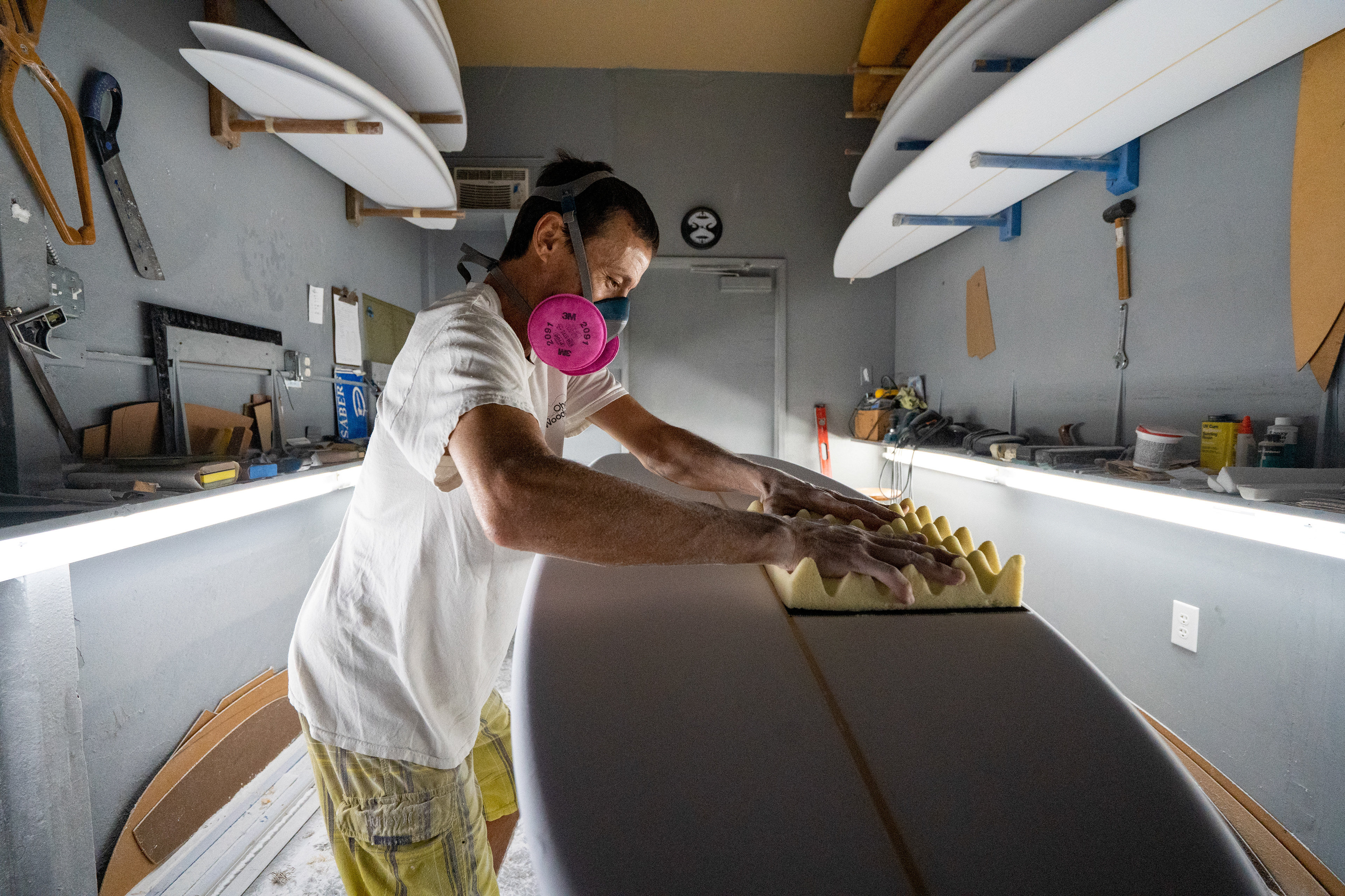Haiku, HI - AUGUST 28: Surfboard shaper Jud Lau shapes a board at his studio in Haiku, Hawaii on August 28, 2023. Lau starts a surfboard replacement project and has given over a hundred surfboards to surfers who lost their board during the wildfire. (Photo by Mengshin Lin for The Washington Post)