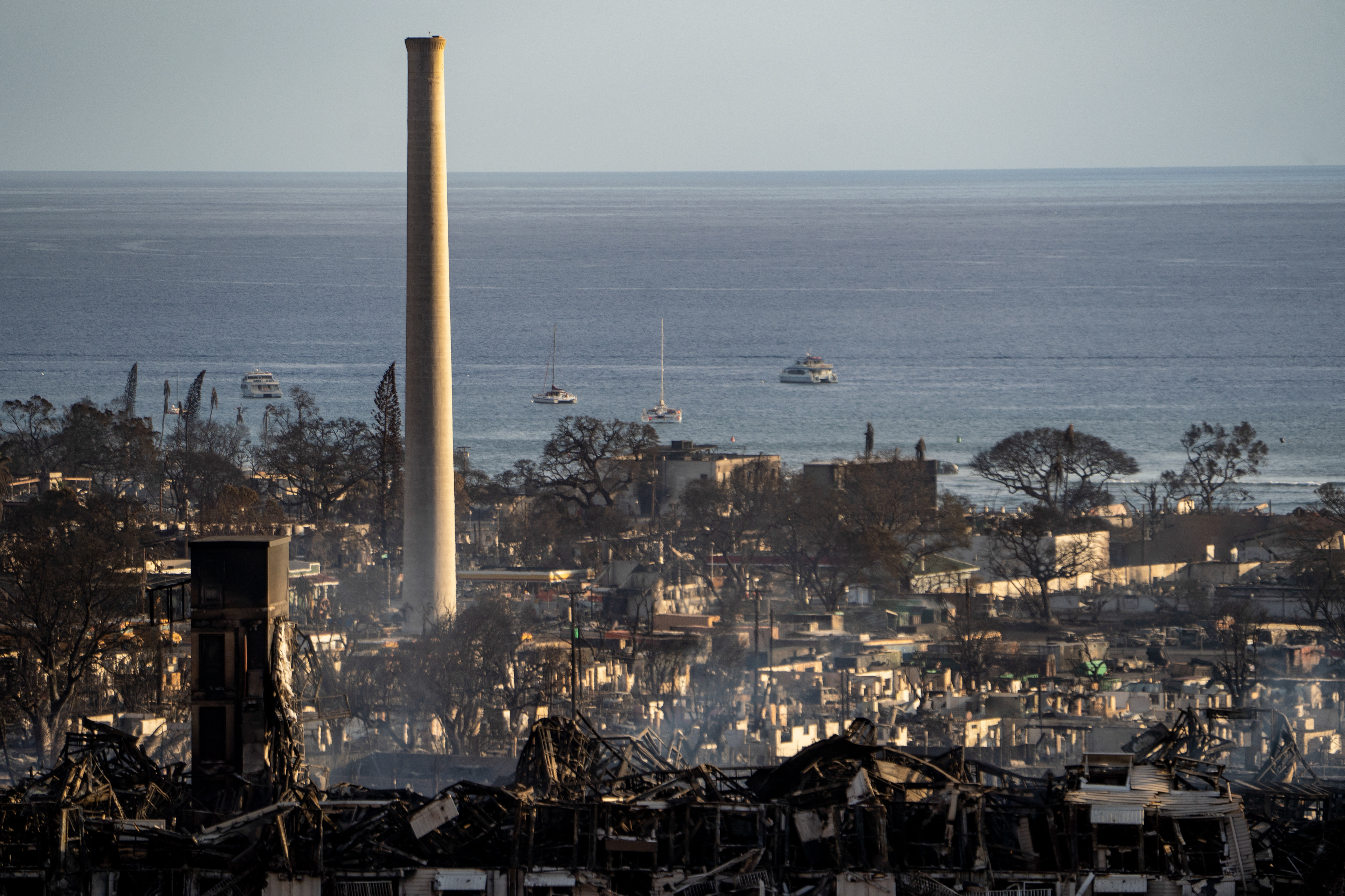Lahaina, HI - AUGUST 23: Smoke rises between the remains of Lahaina during the wildfire in Lahaina, Hawaii on August 10, 2023. (Photo by Mengshin Lin for The Washington Post)