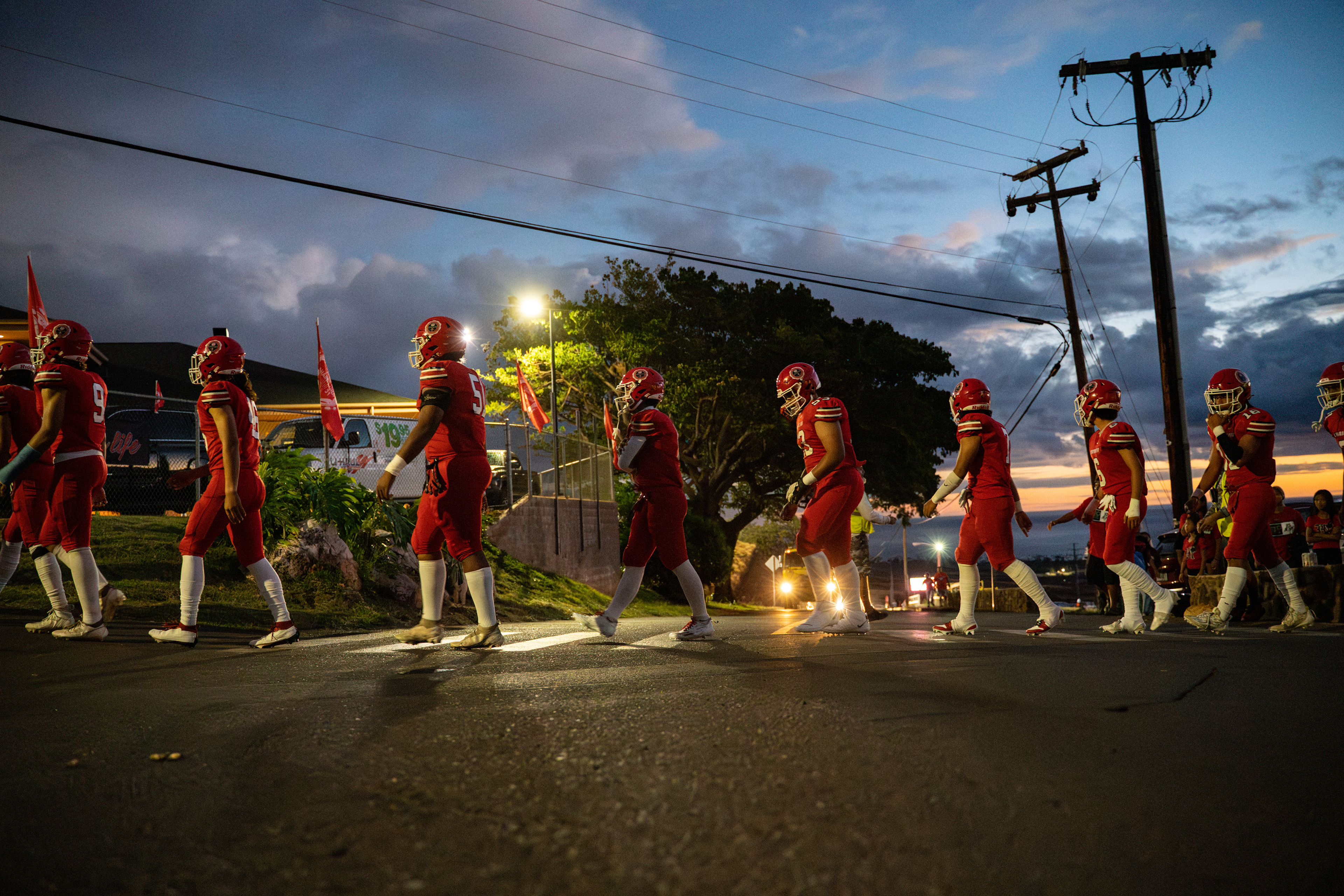 Lahainaluna football team walk to the field at Sue D. Cooley Stadium on Saturday, Oct. 21, 2023, in Lahaina, Hawaii. (AP Photo/Mengshin Lin)