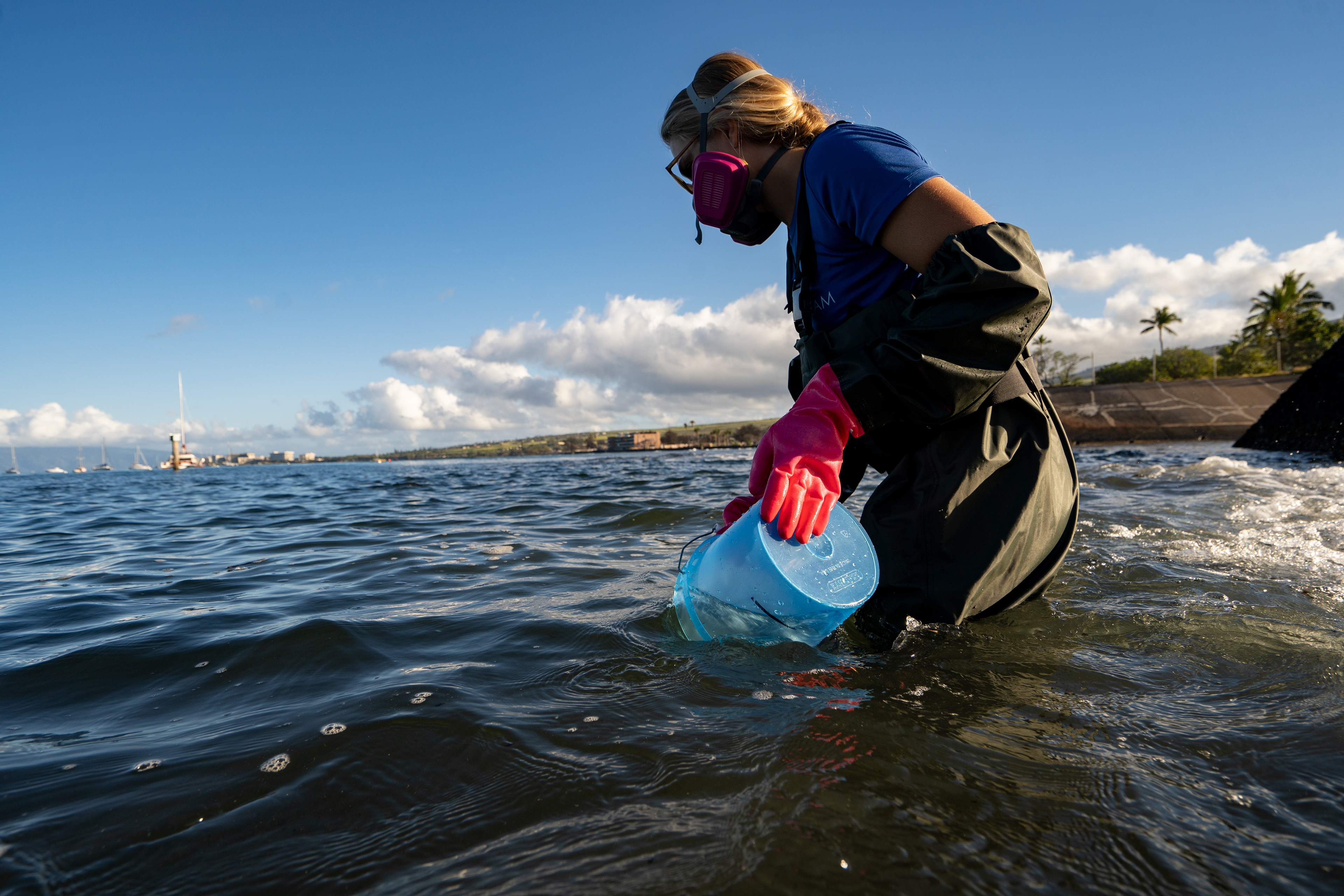 Christiane Keyhani, program coordinator of Hui O Ka Wai Ola, fills up the bucket to test water quality at the Mala Wharf on Friday, Feb. 23, 2024, in Lahaina, Hawaii. (AP Photo/Mengshin Lin)  