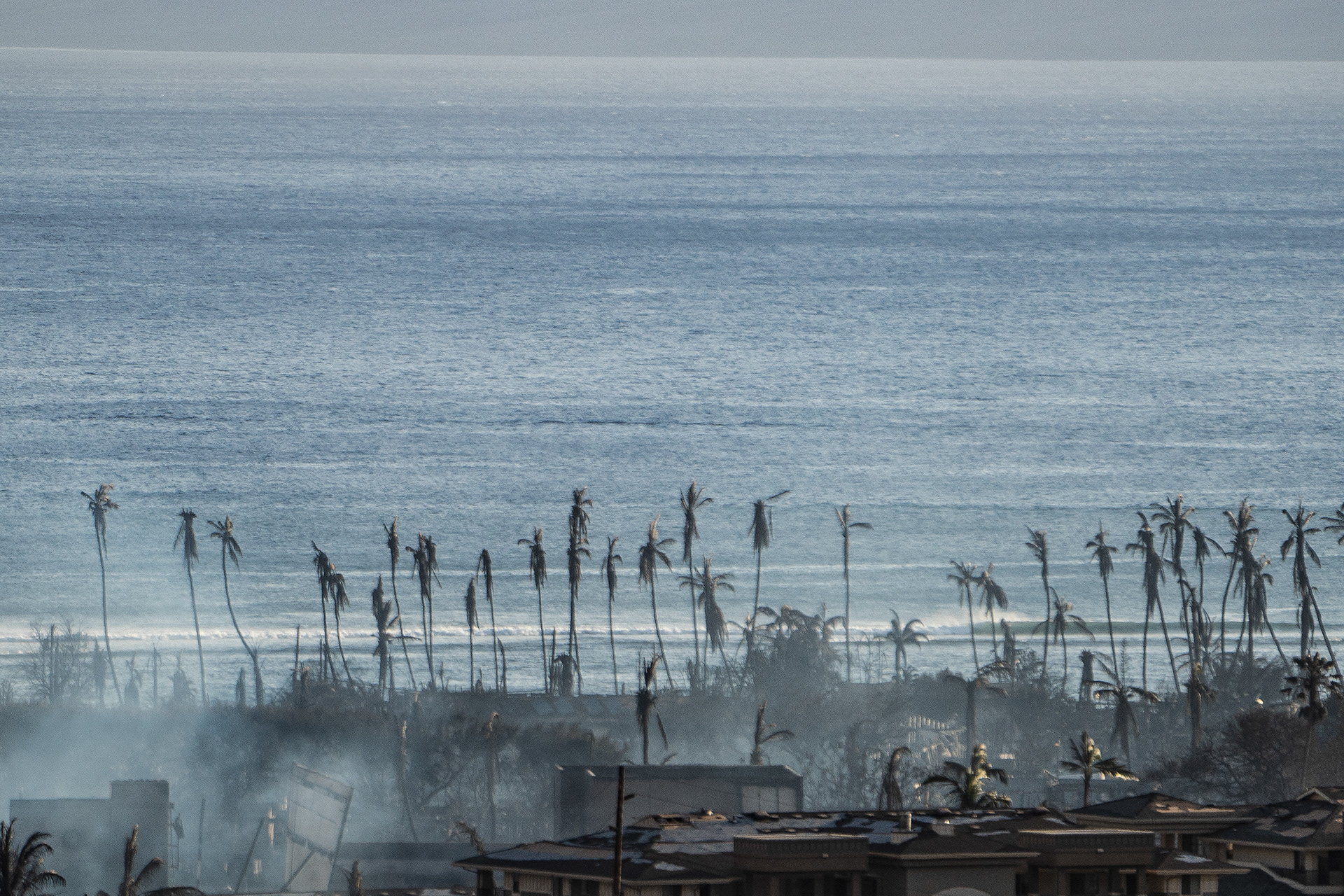 Lahaina, HI - AUGUST 23: Smoke rises between the remains of Lahaina during the wildfire in Lahaina, Hawaii on August 10, 2023. (Photo by Mengshin Lin for The Washington Post)