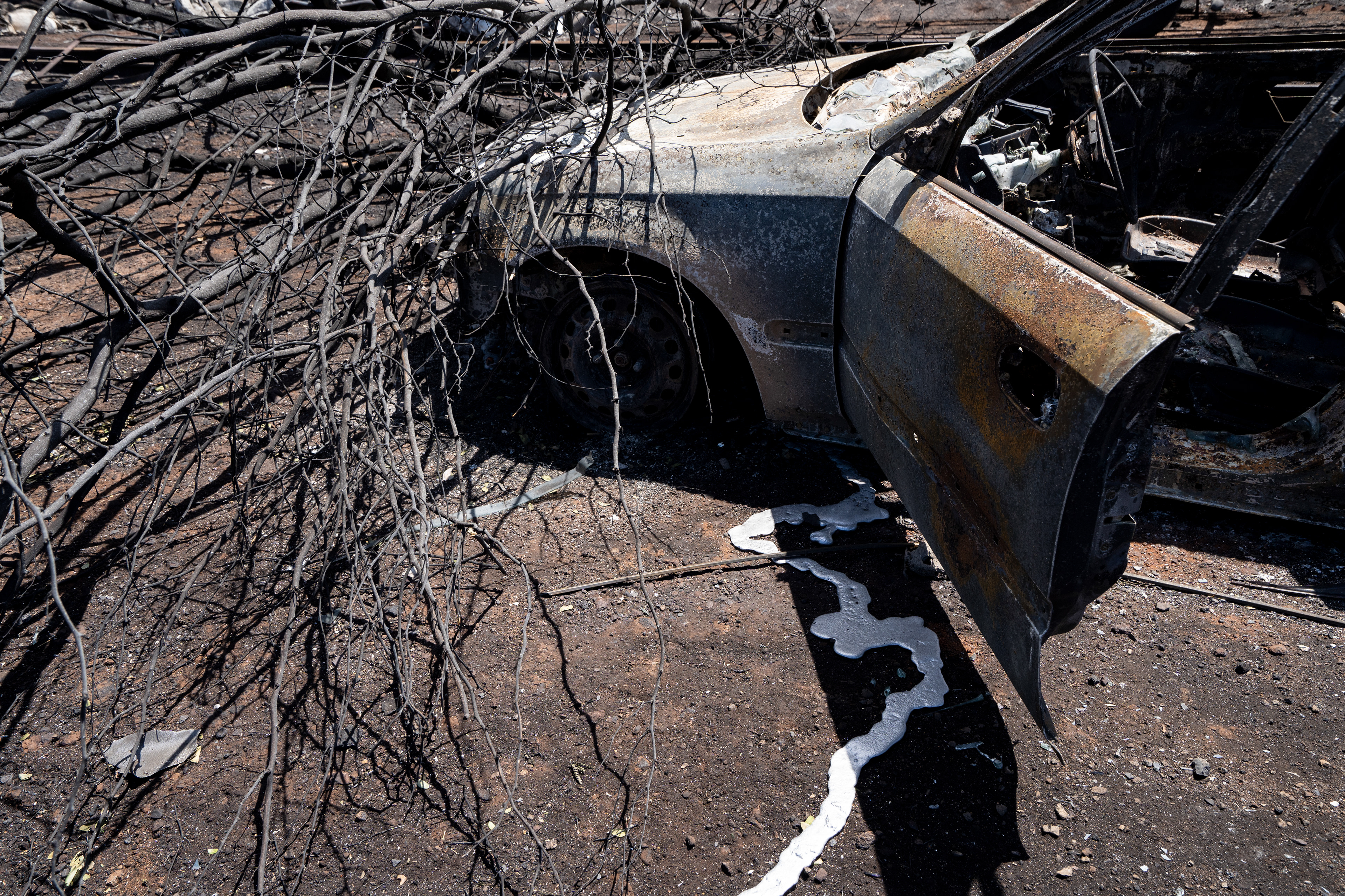 Lahaina, HI - AUGUST 23: Melted aluminum is pictured from a burned car at Waikuli Terrace in Lahaina, Hawaii on August 10, 2023. (Photo by Mengshin Lin for The Washington Post)