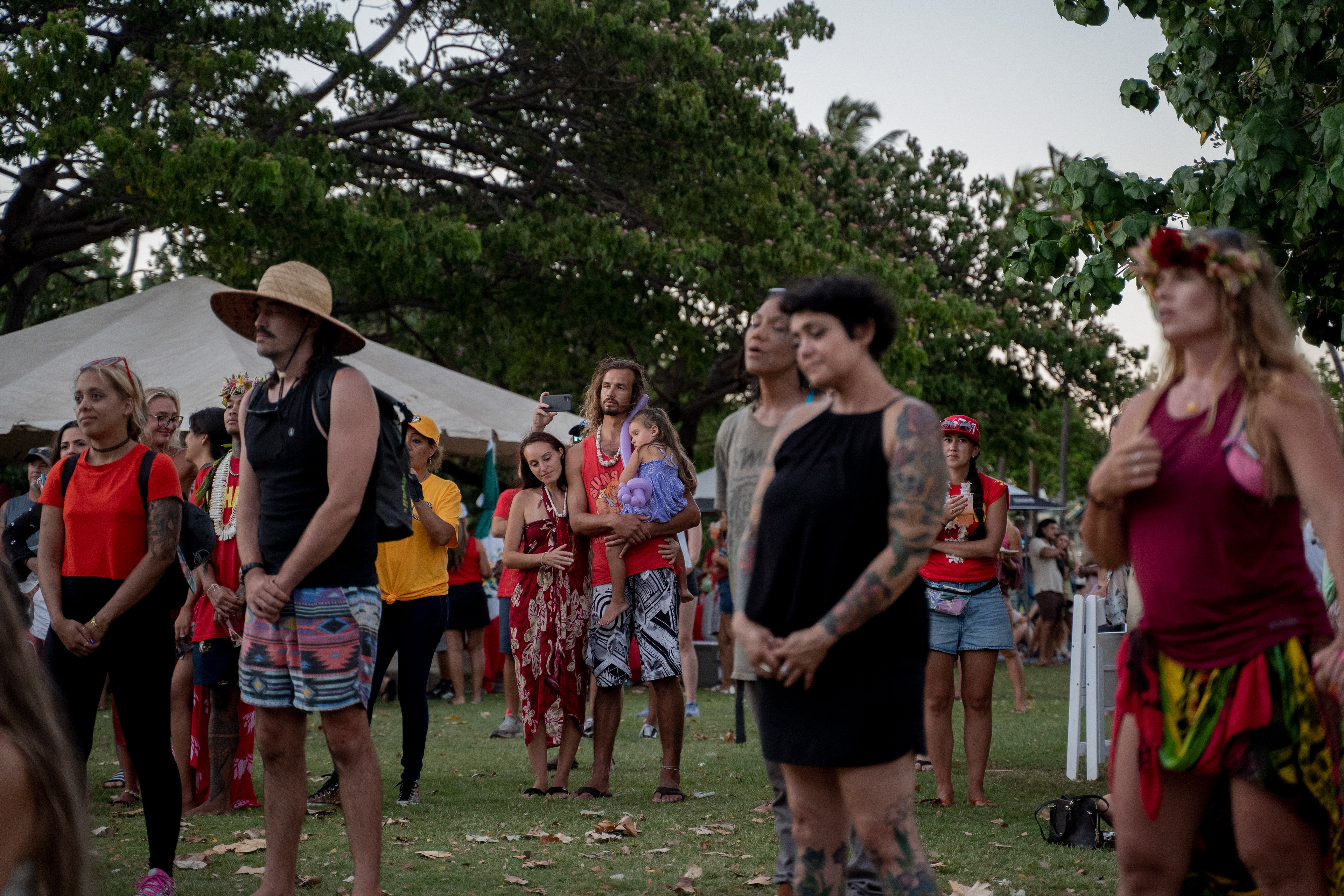 Kihei, HI - SEPTEMBER 8: People sings Hawaii Aloha during a community gathering for the one-month anniversary of the Lahaina Fire at Kalama Beach Park in Kihei, Hawaii on September 8, 2023. (Photo by Mengshin Lin for The Washington Post)