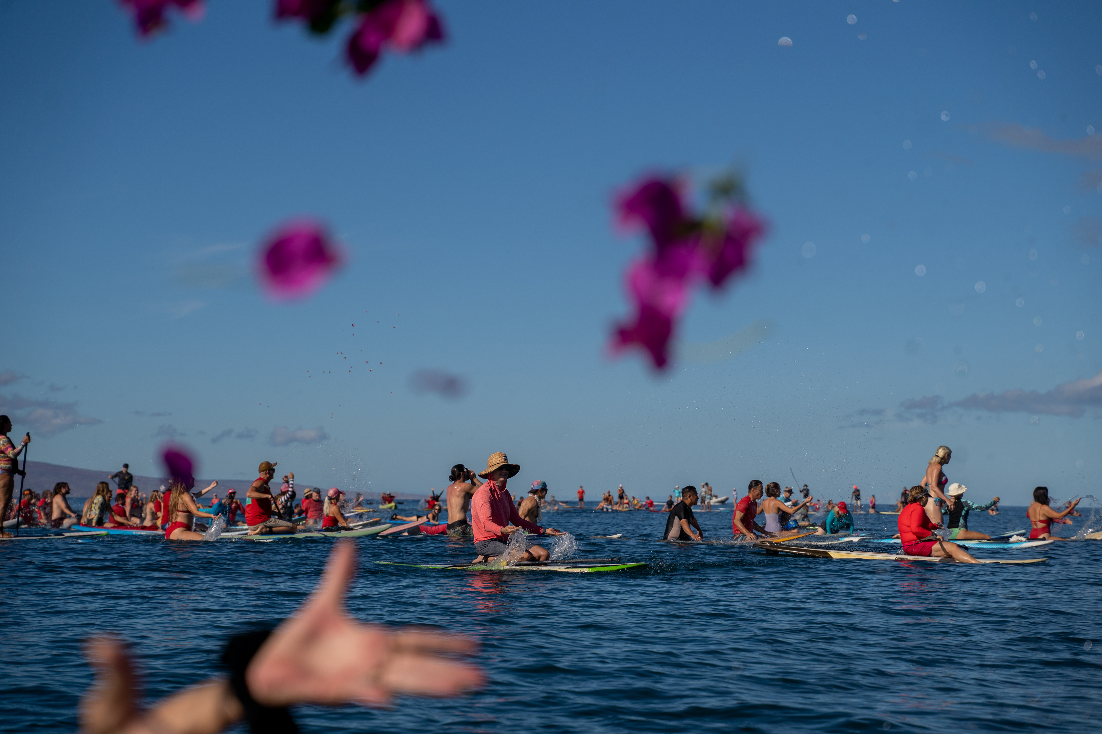 Kihei, HI - SEPTEMBER 8: Dozens surfers gather for a memorial paddle out on the one-month anniversary of the Lahaina Fire at Kalama Beach Park in Kihei, Hawaii on September 8, 2023. (Photo by Mengshin Lin for The Washington Post)