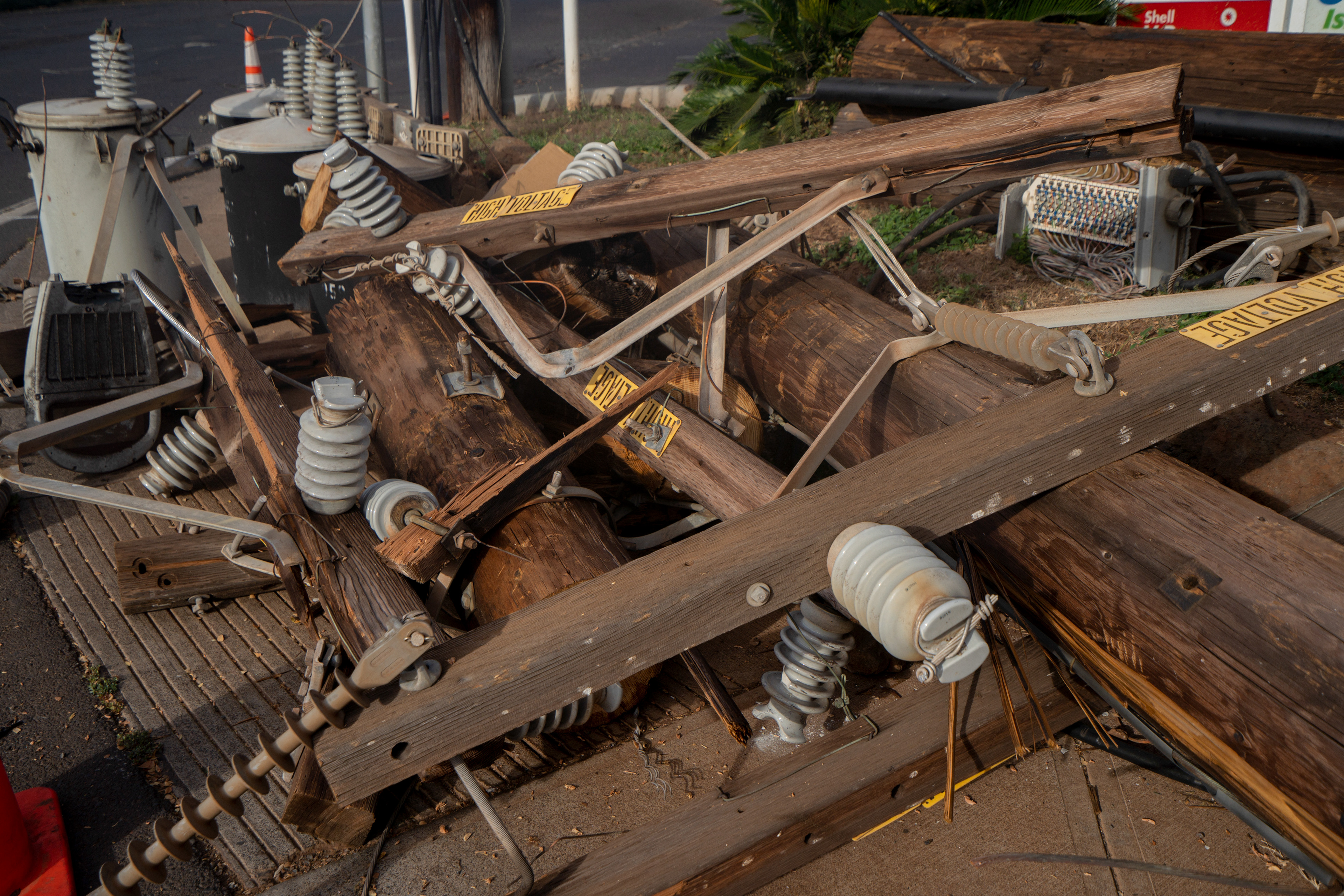 LAHAINA, HI - AUGUST 21: Fallen utilities poles are pictured outside of a gas station on Lahainaluna Road in Lahaina, Hawaii on August 21, 2023. (Photo by Mengshin Lin for The Washington Post)