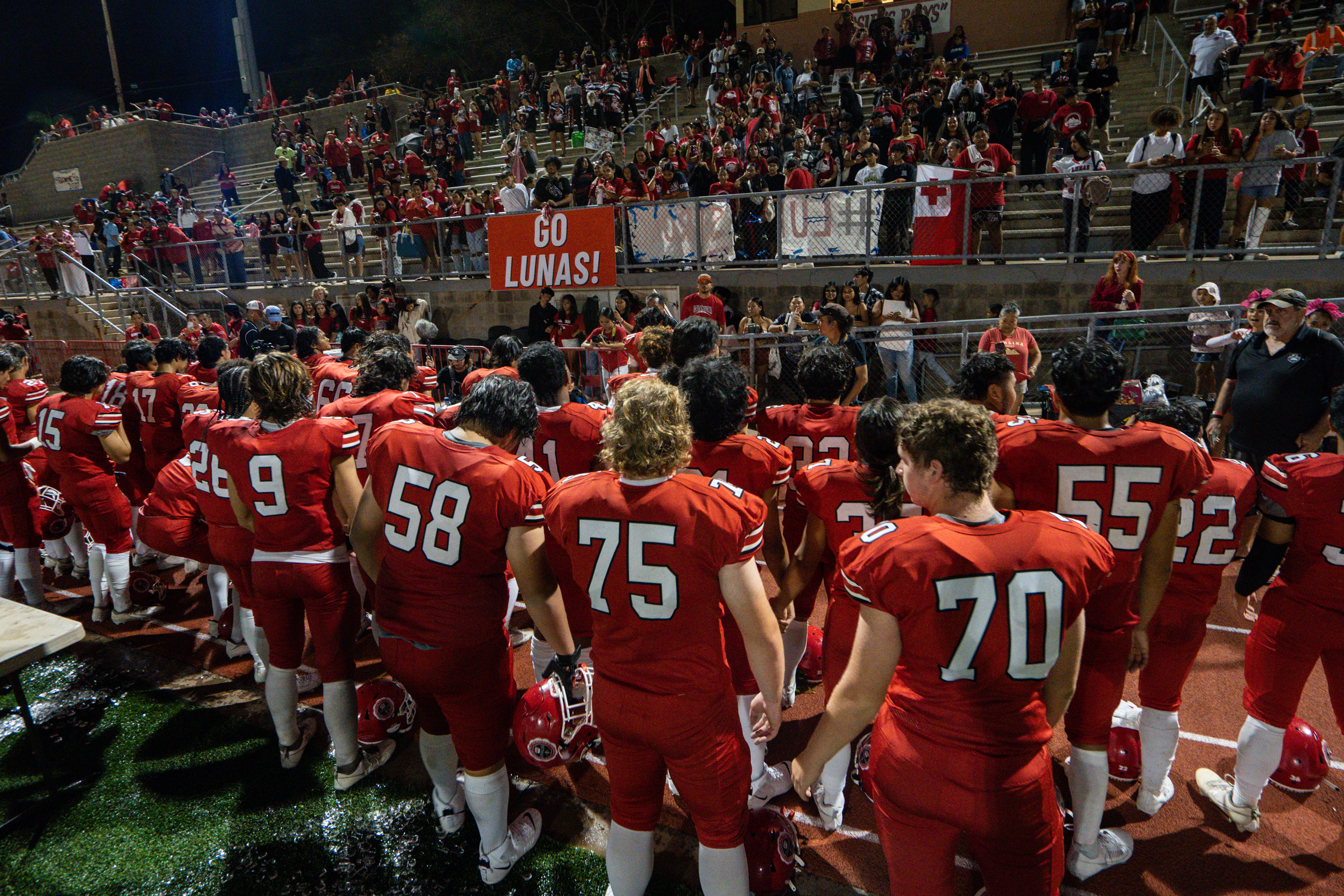 Lahainaluna football team hold their hands to thank the fans after the game at Sue D. Cooley Stadium on Saturday, Oct. 21, 2023, in Lahaina, Hawaii. (AP Photo/Mengshin Lin)
