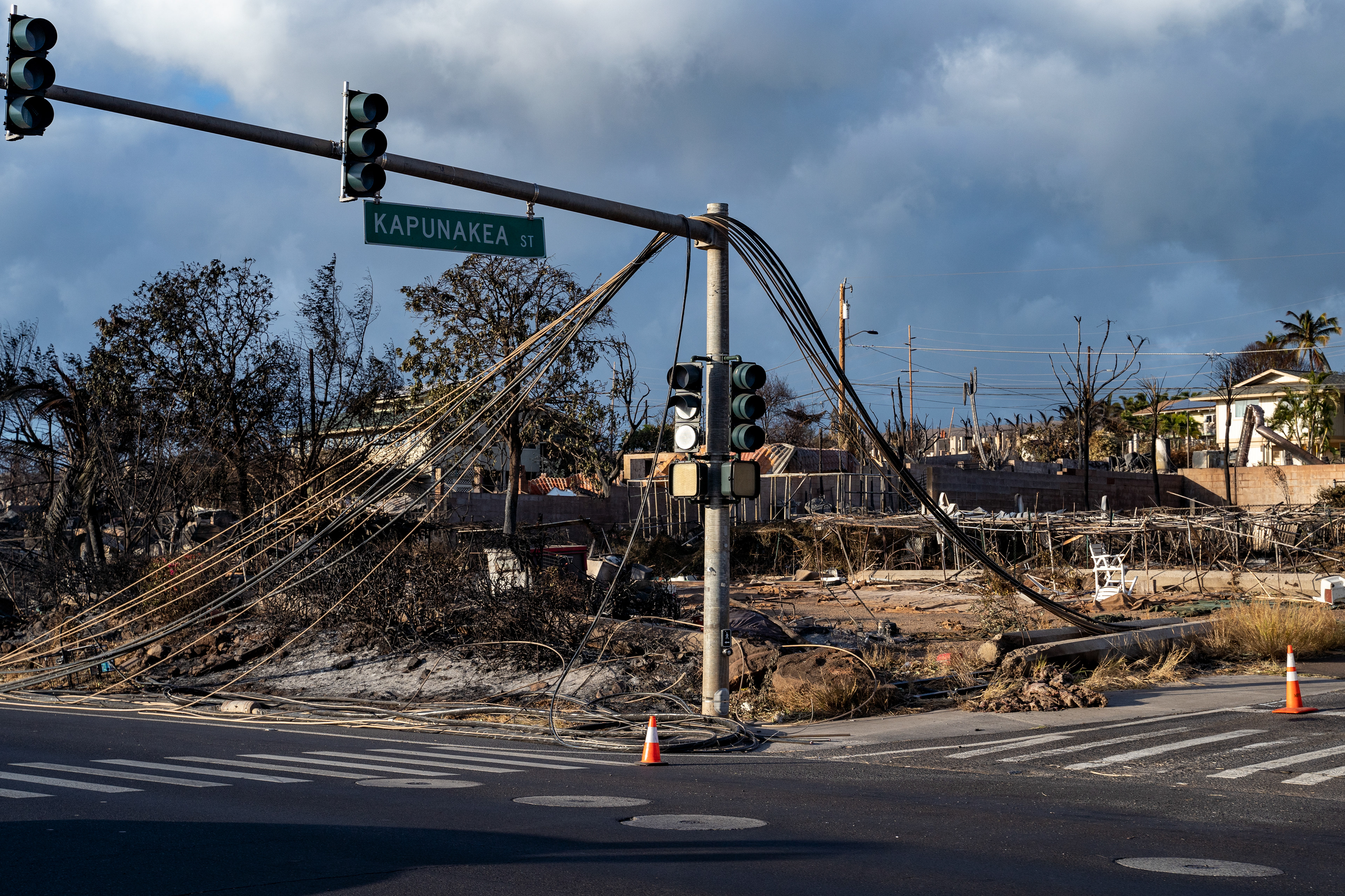 Lahaina, HI - AUGUST 23: A fallen telephone pole is pictured after the wildfire at the intersection of Kapunakea Street and Honoapiilani Highway in Lahaina, Hawaii on August 10, 2023. (Photo by Mengshin Lin for The Washington Post)