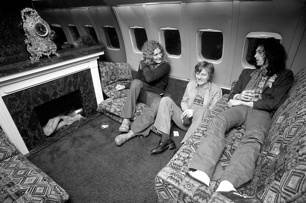 Jan 31, 1975. Led Zepellin travel from Newark airport, New Jersey to Detroit, Michigan. They travel in their custom fitted Boeing 707 which, among other luxuries has a working fireplace. L/R: Robert Plant, John Paul Jones and Jummy Page.