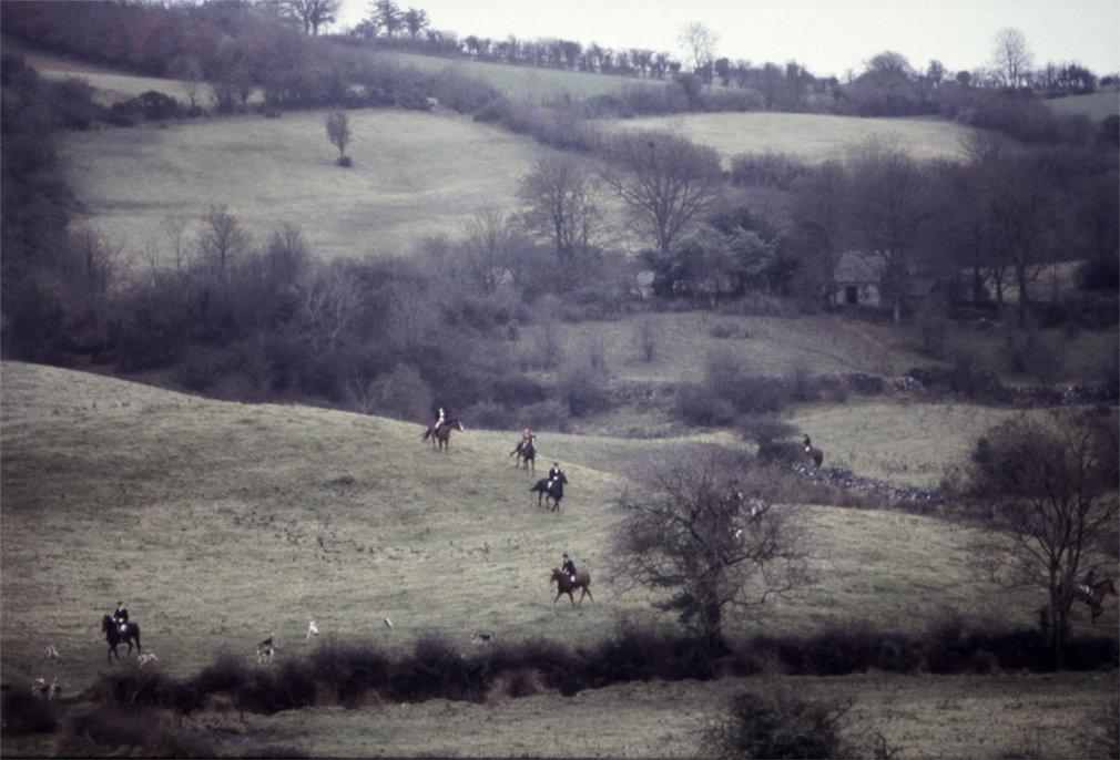 Glaslough, Co.Monaghan. Ireland. 1980. The members of The Scarteen Hunt cross the fields near the small village of Glaslough.