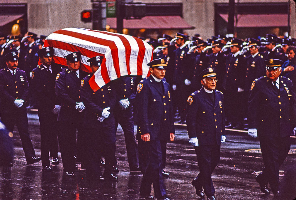 NYPD officer killed in the line of duty. The funeral precession marches up Fifth Avenue, funeral. 1990's