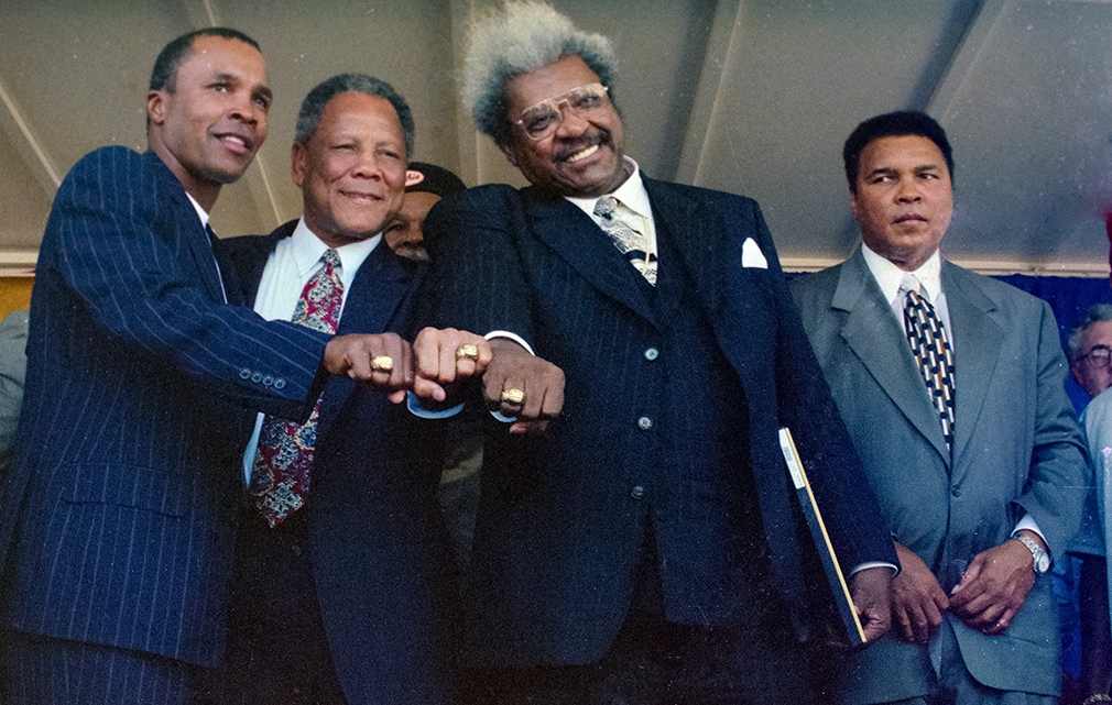 Canastota, Ny; July 1997. Boxing promoter Don King along with (L/R) "Sugar" Ray Leonard, Jose Torres, Don King. are inducted into The International Boxing Hall of Fame. Muhammad Ali one of the first ever inductees watches.