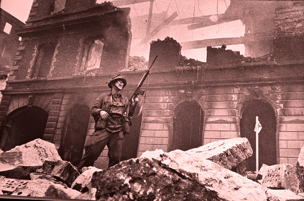 A soldier from the First Regiment of Wales stands guard on The Lower Falls Road. August 15, 1969.