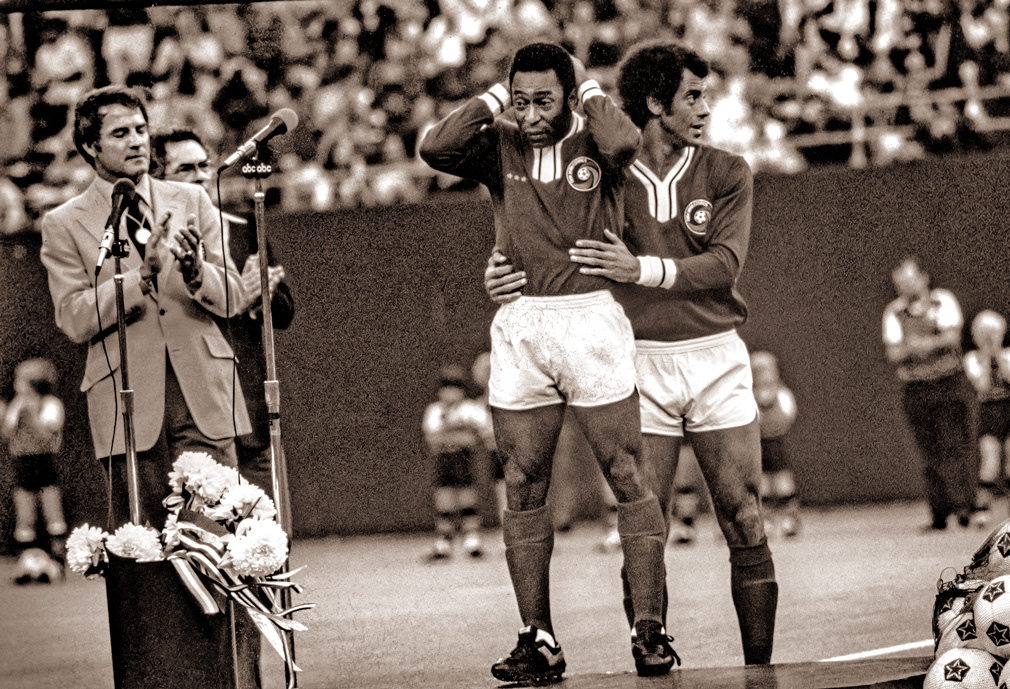 Rutherford, NJ. October 1, 1977. Pele reacts to seventy thousand adoring fans prior to playing his last game at Giants Stadium.. He is consoled by Brazilian team-mate and National team captain Carlos Alberto.
