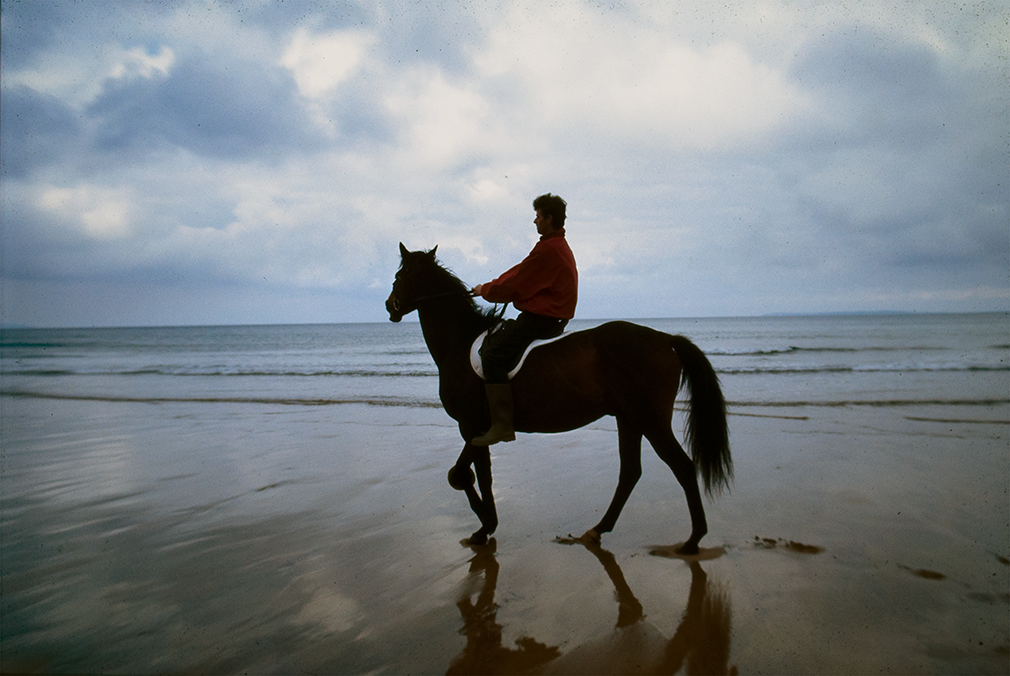 Ballybunion, Co.Kerry, Ireland. 1996.A moment, a split second relief from the shite of this time. The animal having been troubled by it's right foreleg is asked by the rider to contemplate the mighty Atlantic Ocean. The animal's silent screams to run are deafening.