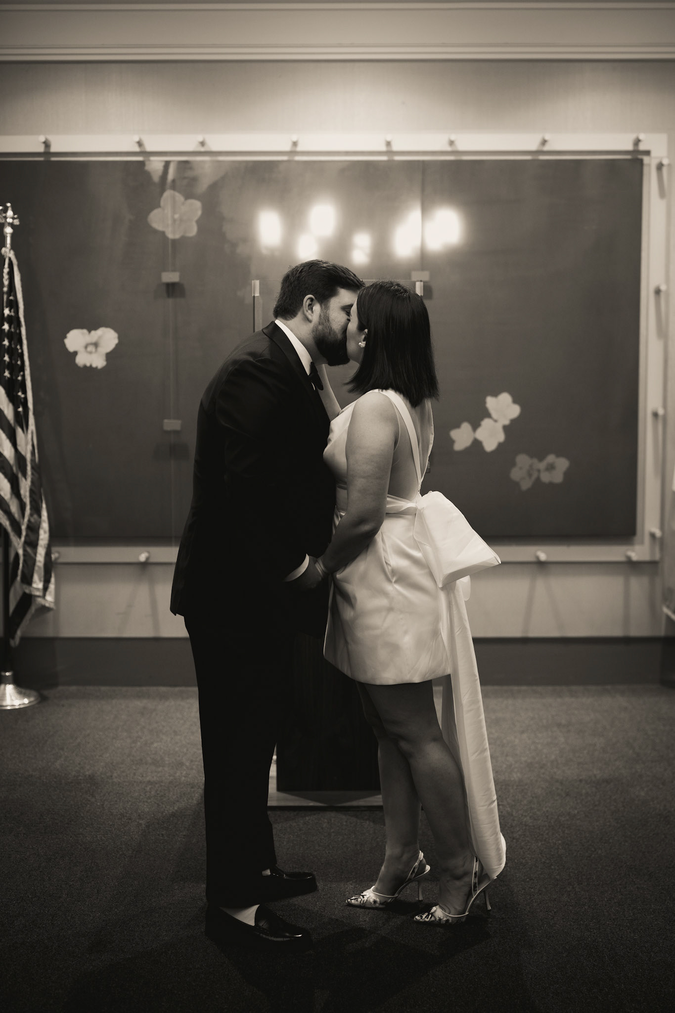 Bride & groom kissing at New York City Hall. Photograph by Catherine Claire Art.