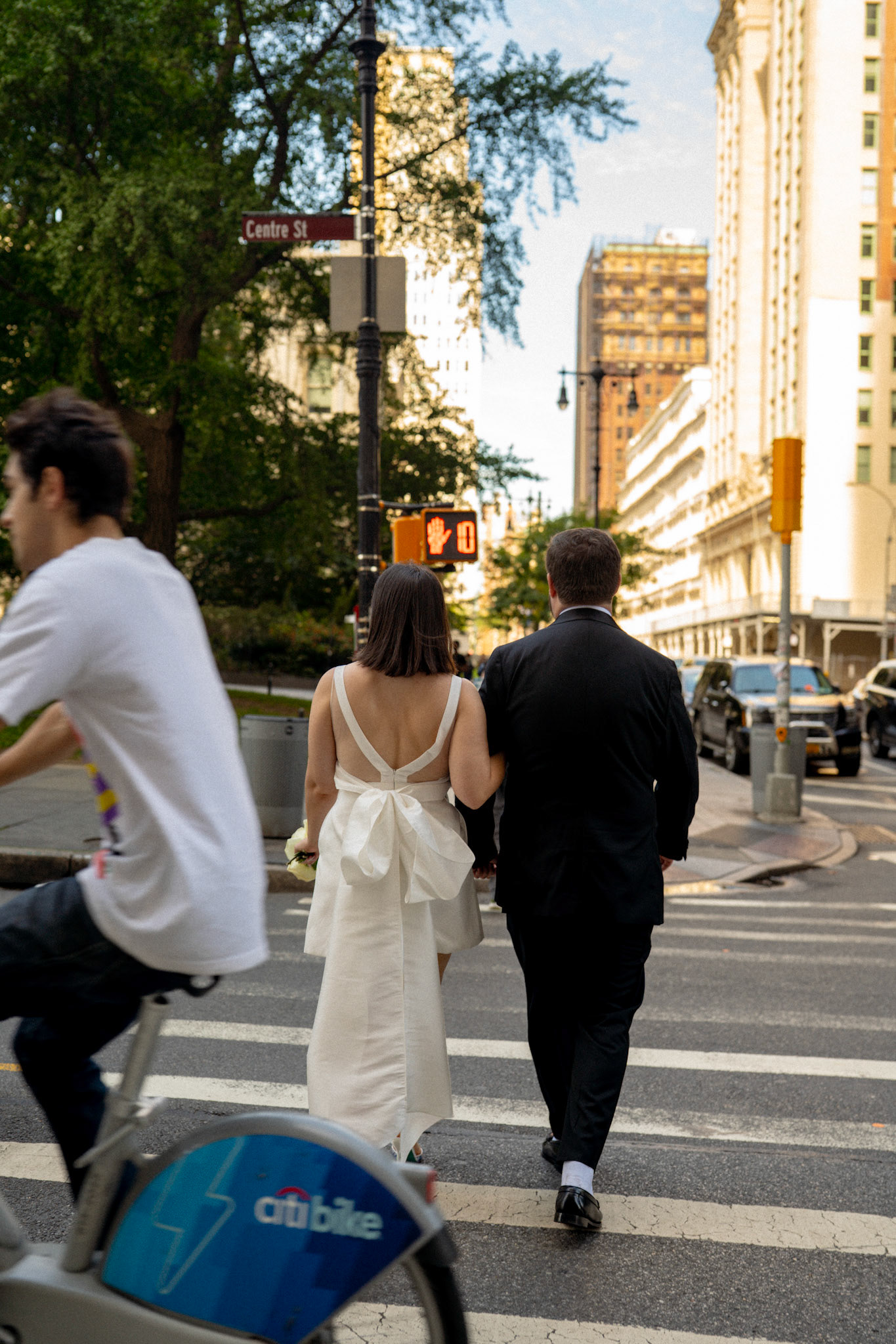 Bride & groom crossing street in downtown Manhattan. Photo by Catherine Claire Art. 