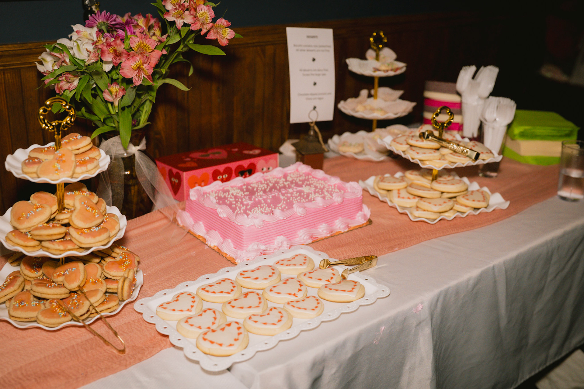 Many pink and heart shaped sweets spread across a table