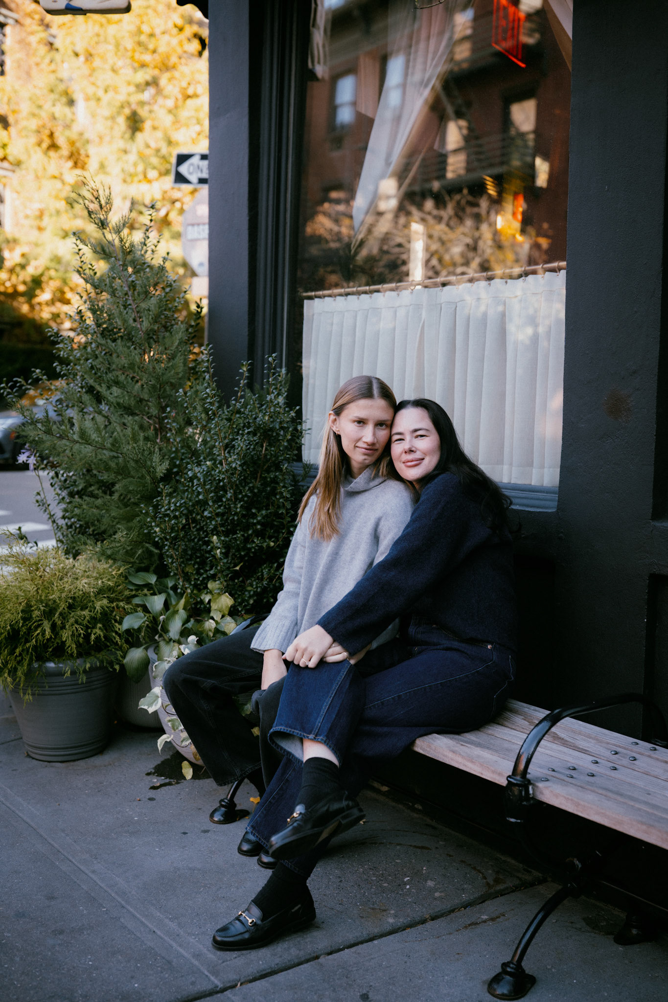 Couple sits in front of the Golden Swan in the West Village.