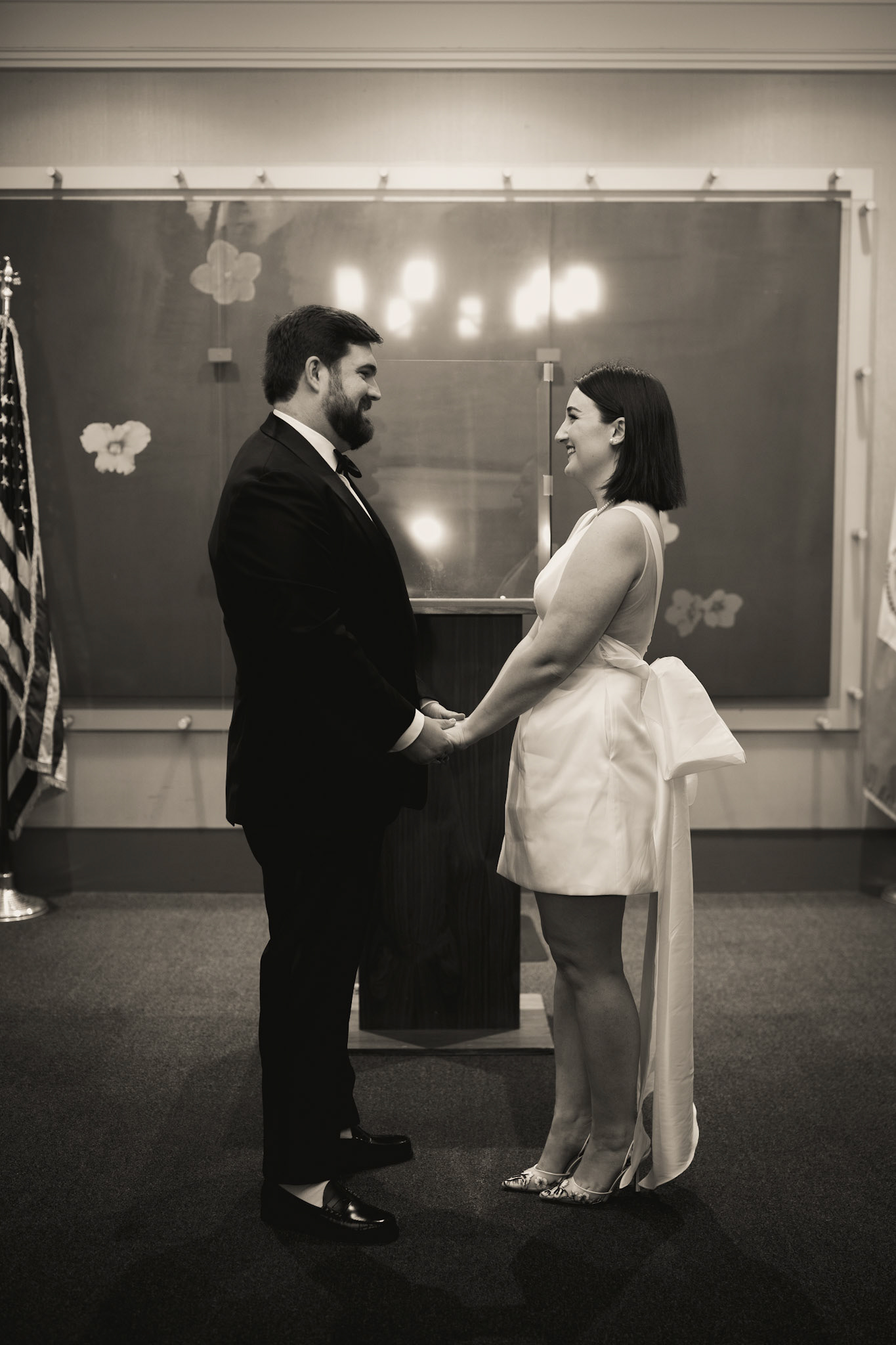 Bride & groom exchanging vows at New York City Hall. Photograph by Catherine Claire Art.