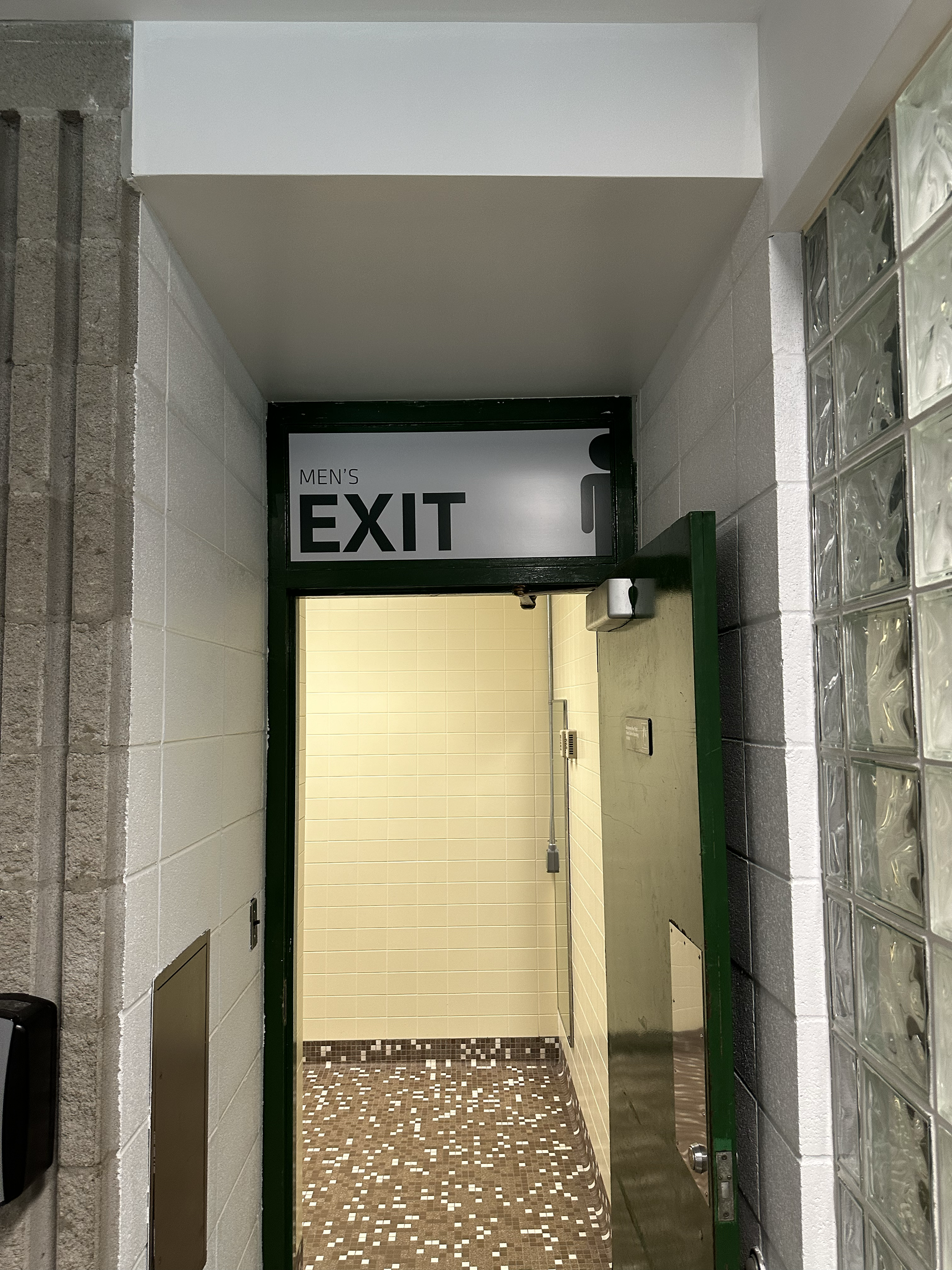 Munn Ice Arena Men's Bathroom Exit Sign