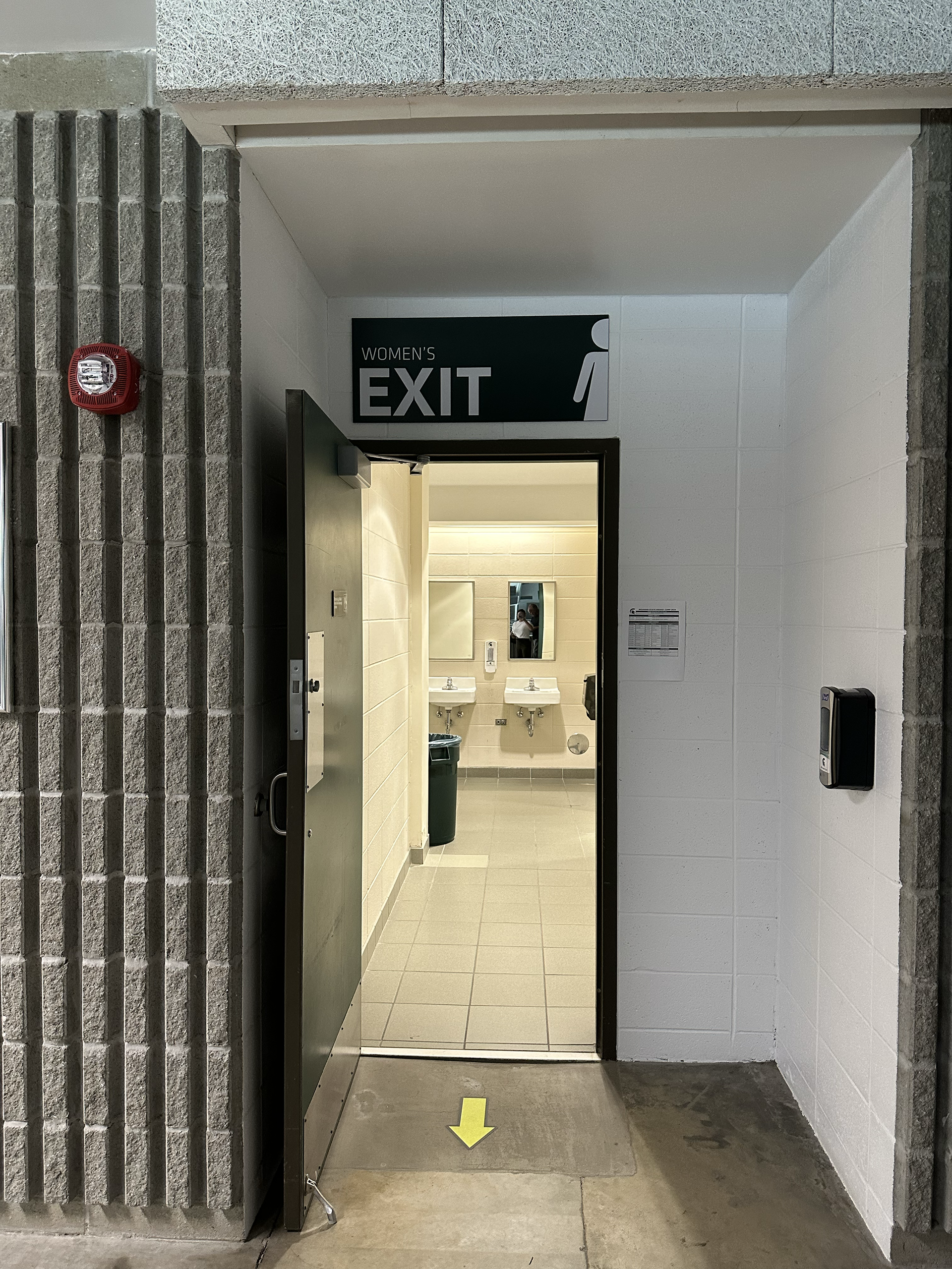 Munn Ice Arena Women's Bathroom Exit Sign