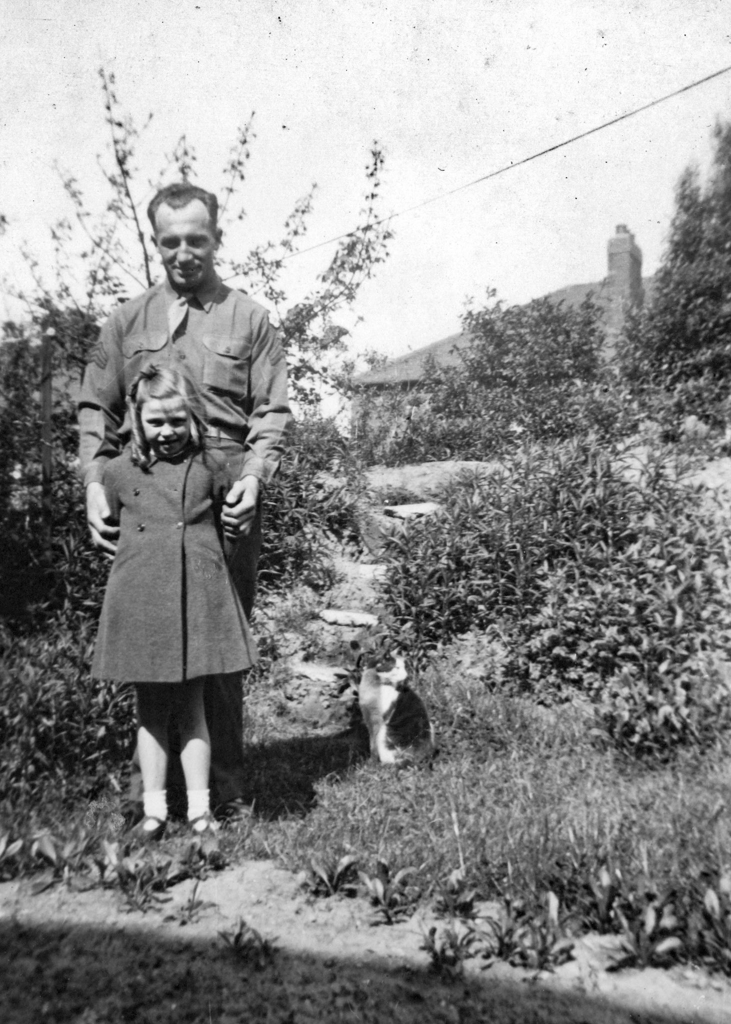"John Orrison and Muriel Casson, Jul 1945 - back yard and bomb shelter Kirkstone Road"
