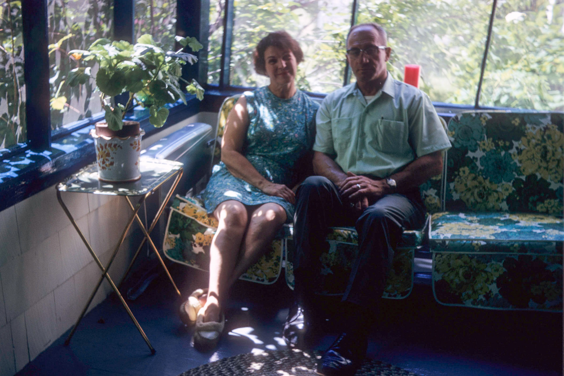 Grace and John on the glider in the front porch at 935