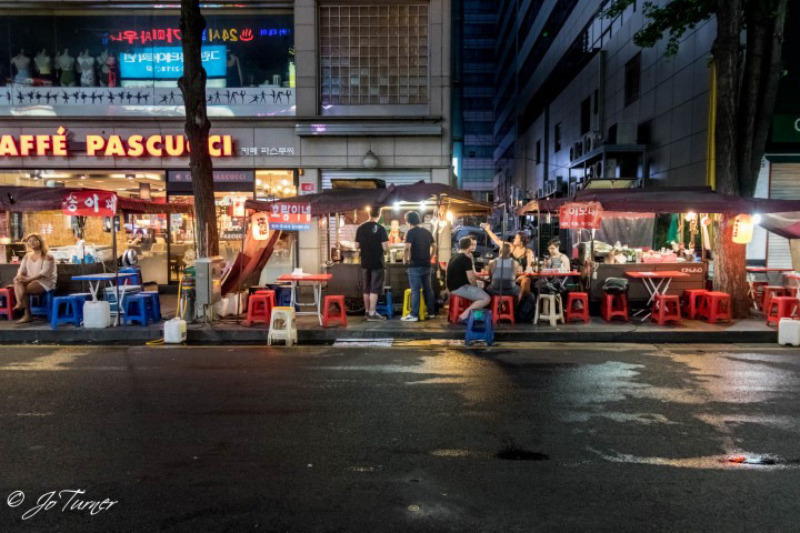 Soju tents against a backdrop of modern cafes