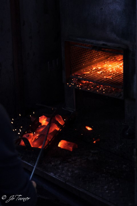 Getting the coals ready for the grills