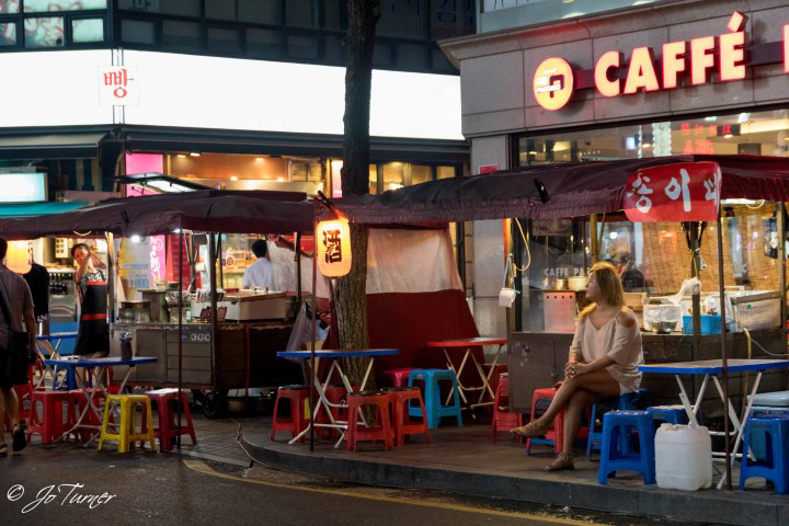 Soju tents against a backdrop of modern cafes